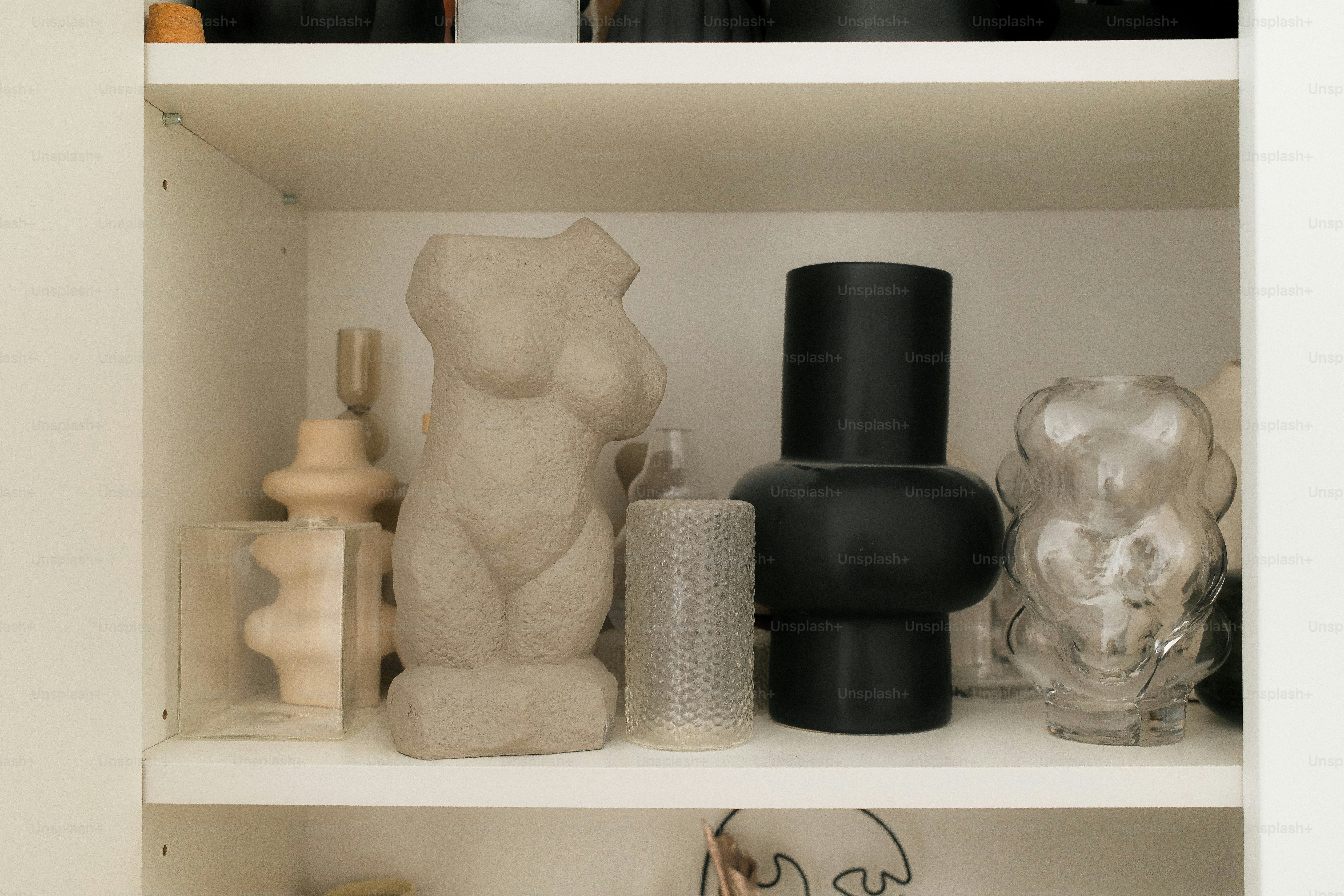 Shelves display decorative sculptures and vases.