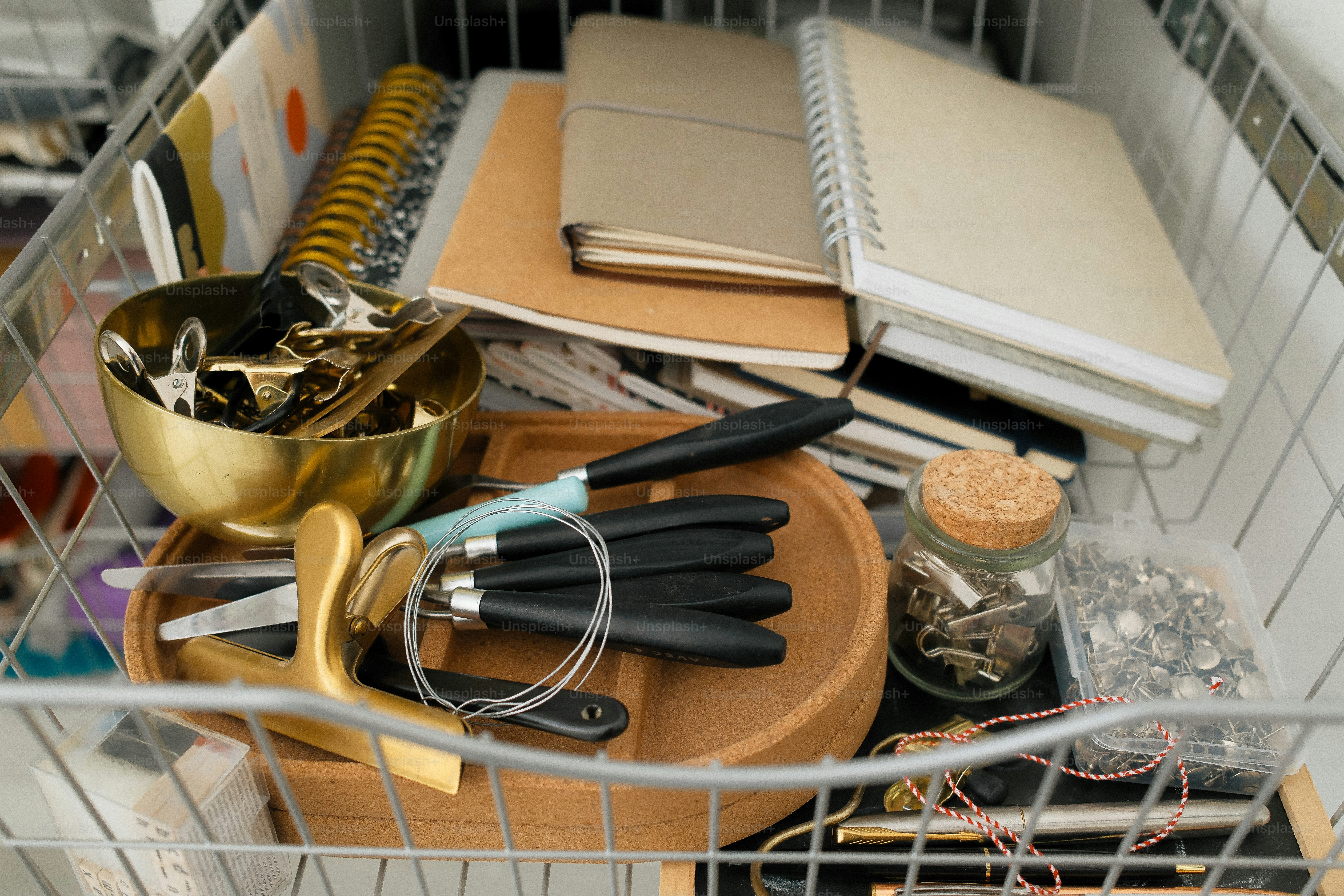 Drawer filled with notebooks, pens, and accessories.