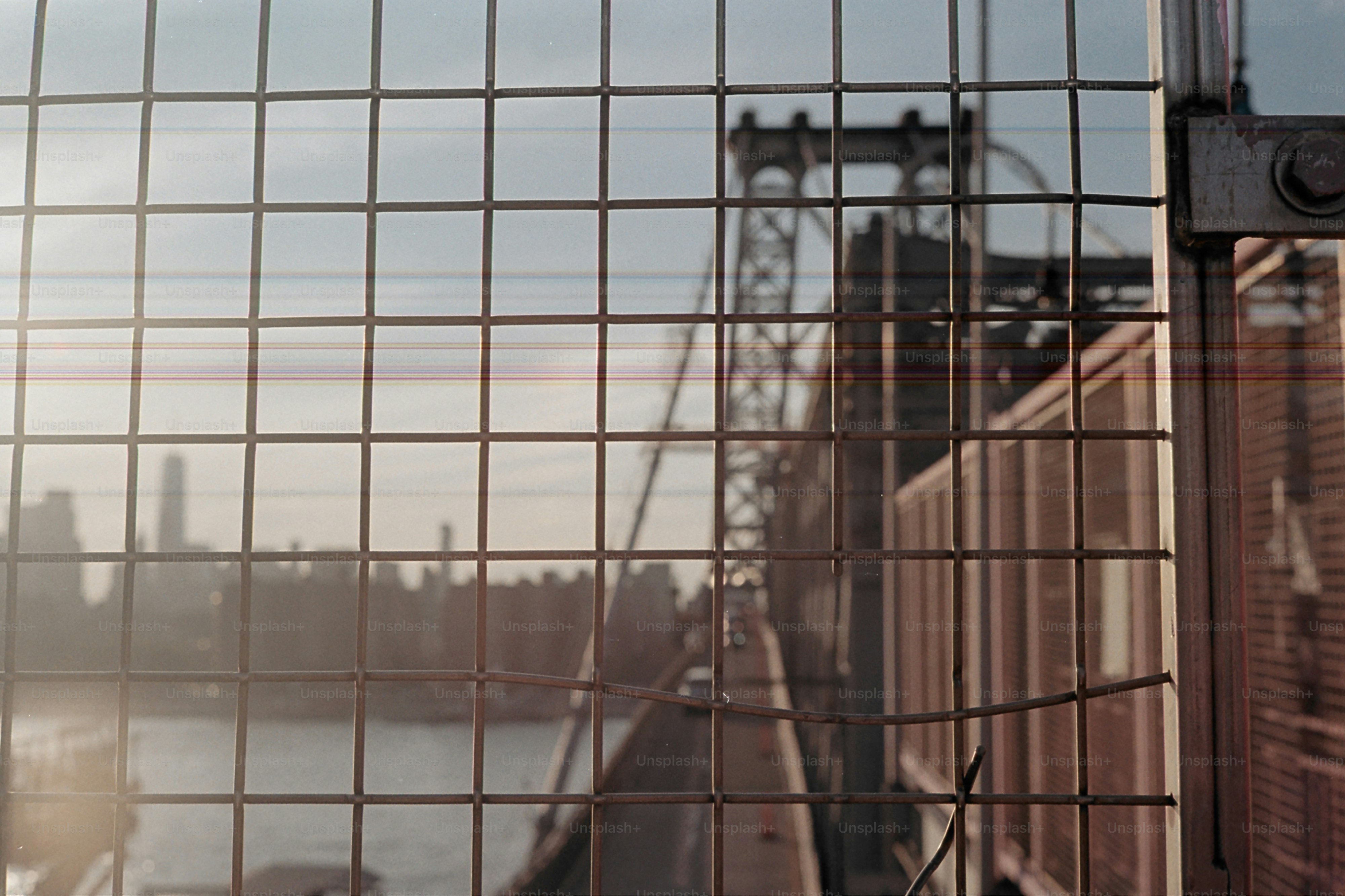 A bridge seen through a protective fence.