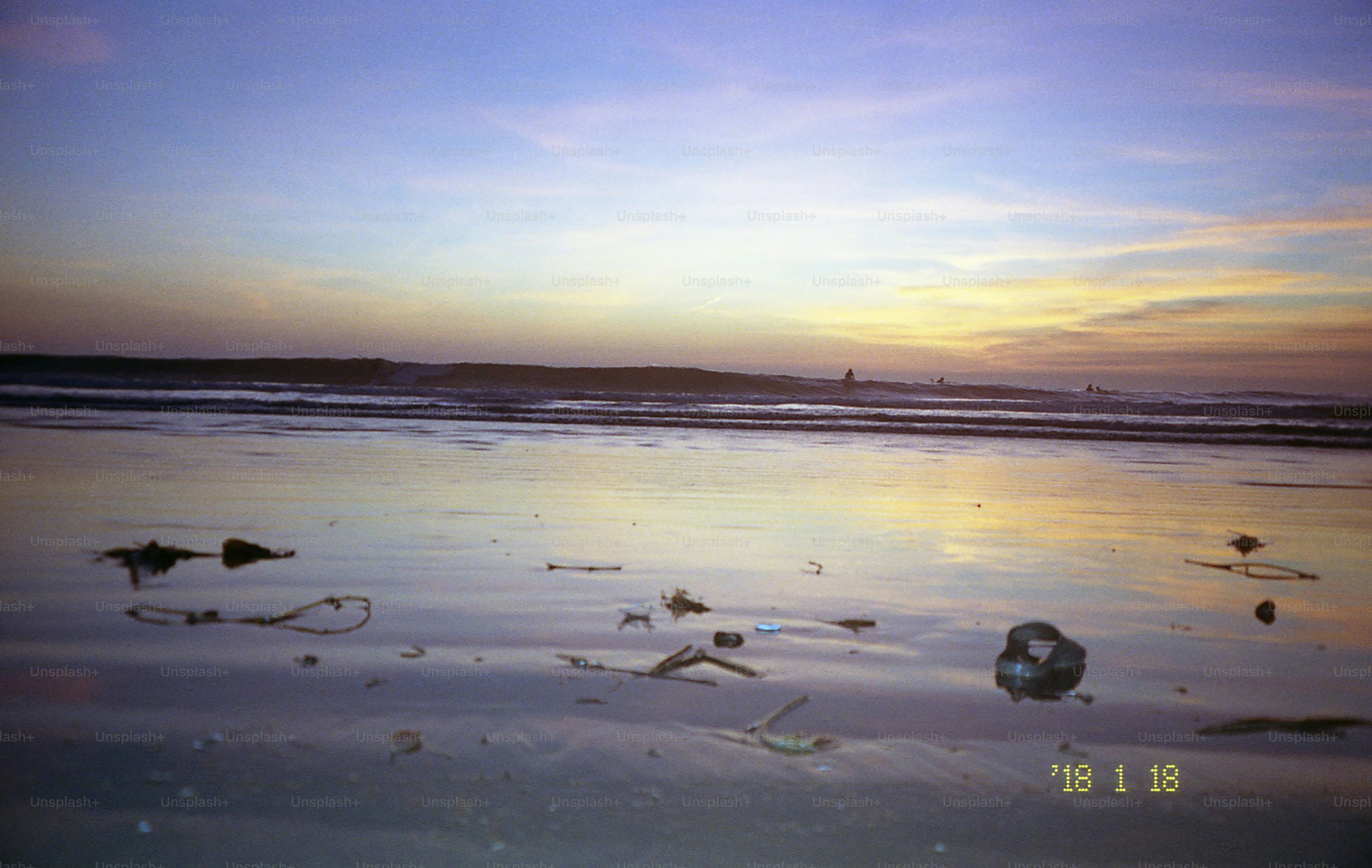 A beach sunset with reflections.