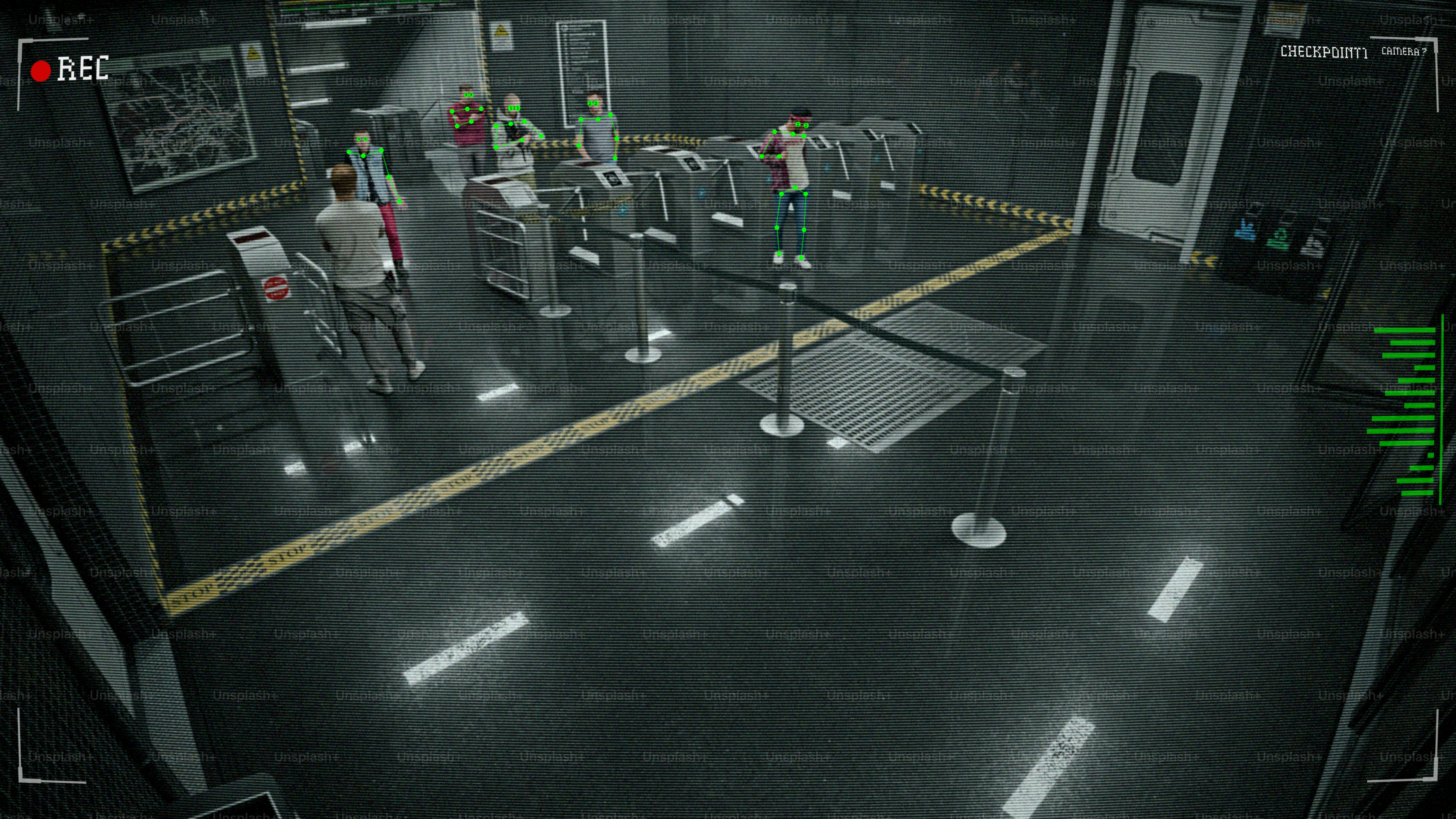 People navigate a turnstile in a sterile, modern environment.