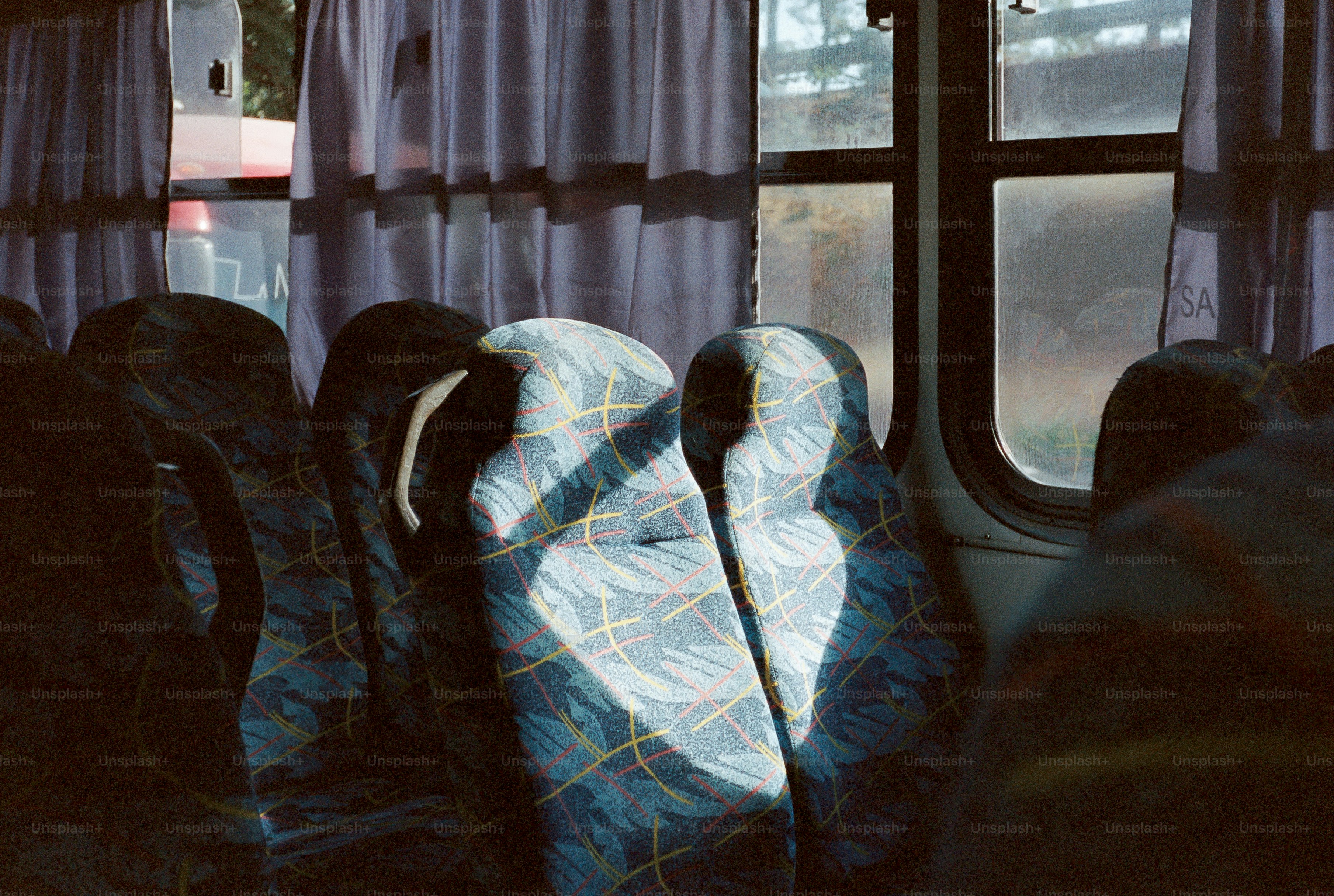 Sunlight streams across empty bus seats.