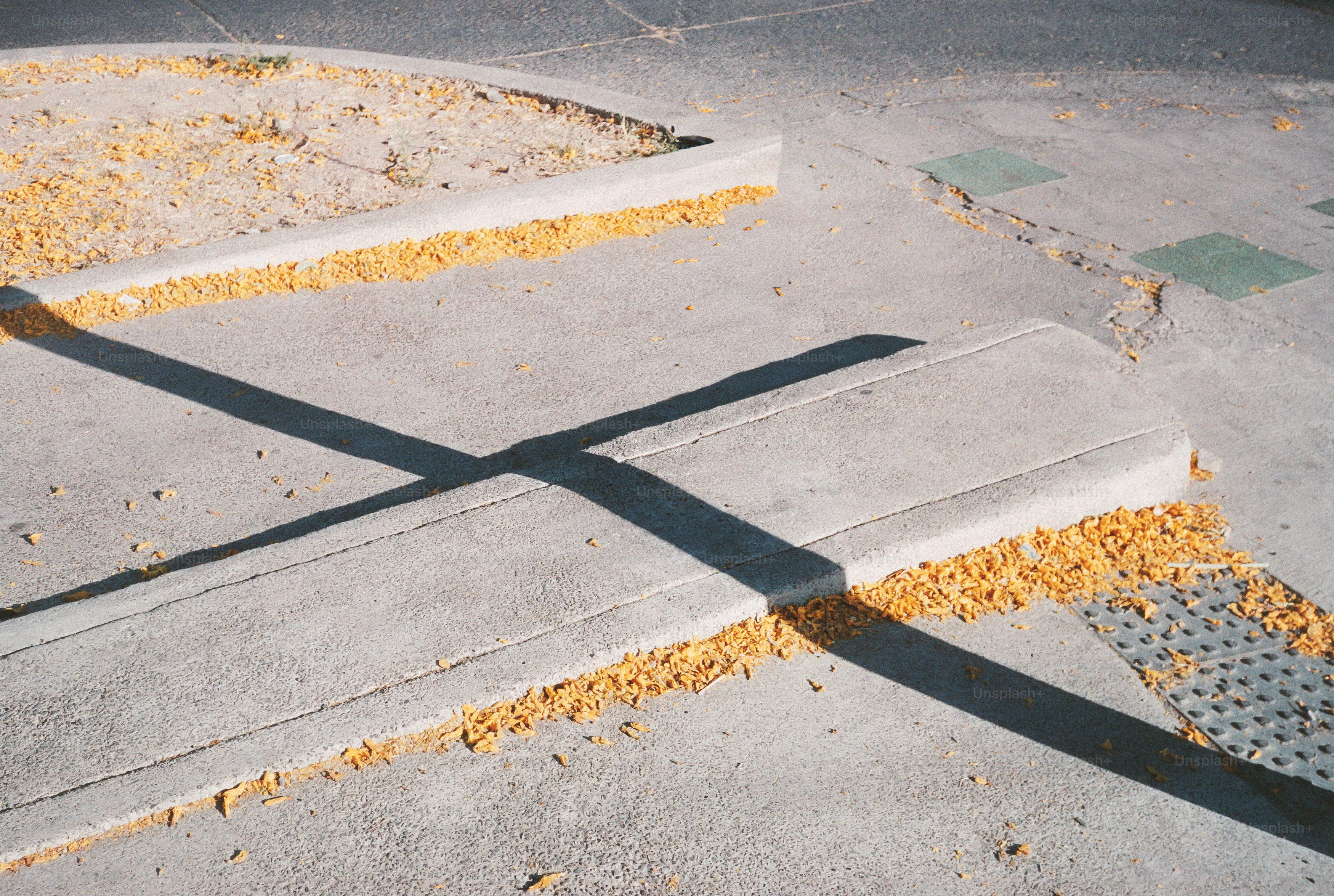 Shadows cross over concrete with debris.