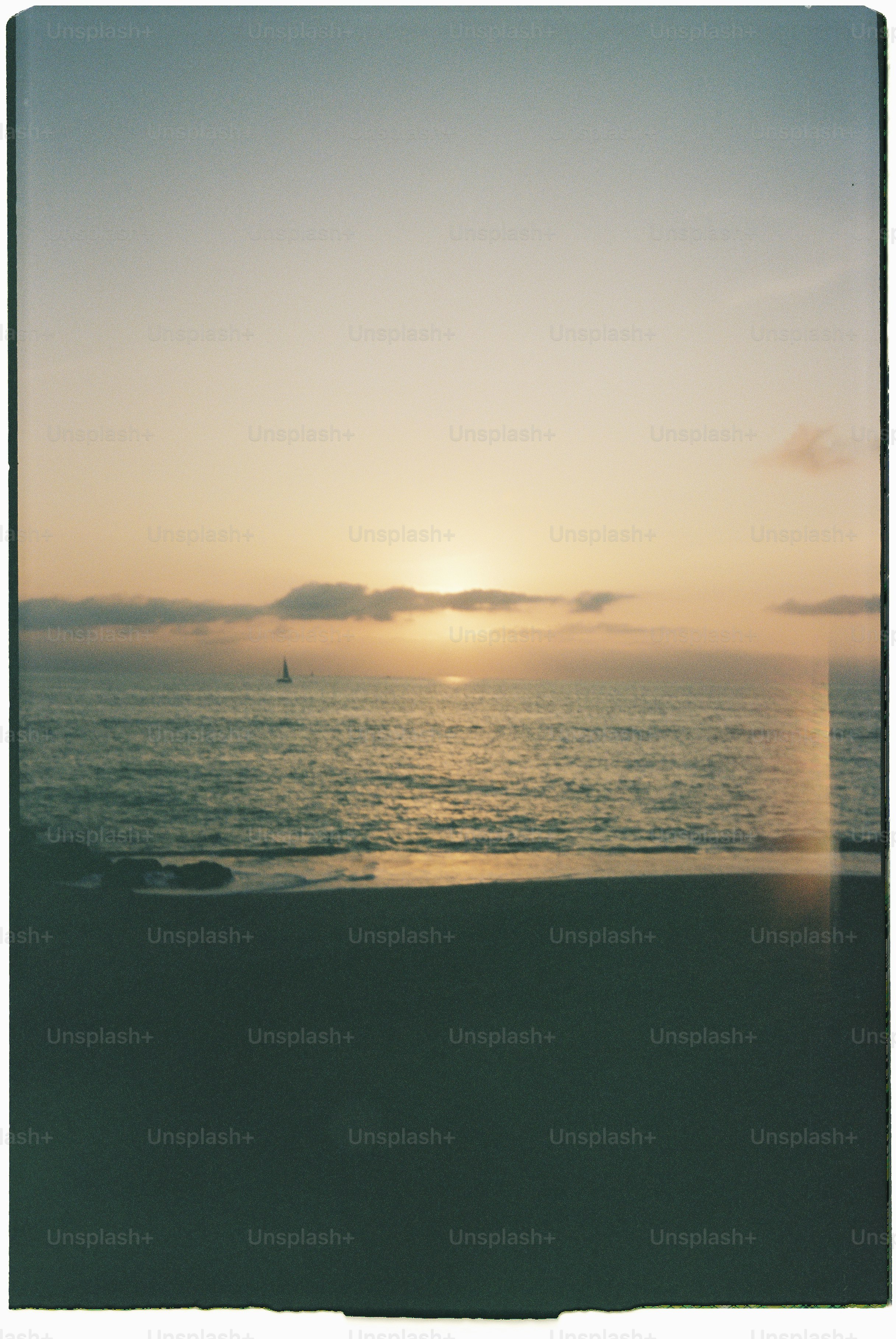 The sun sets over the ocean.