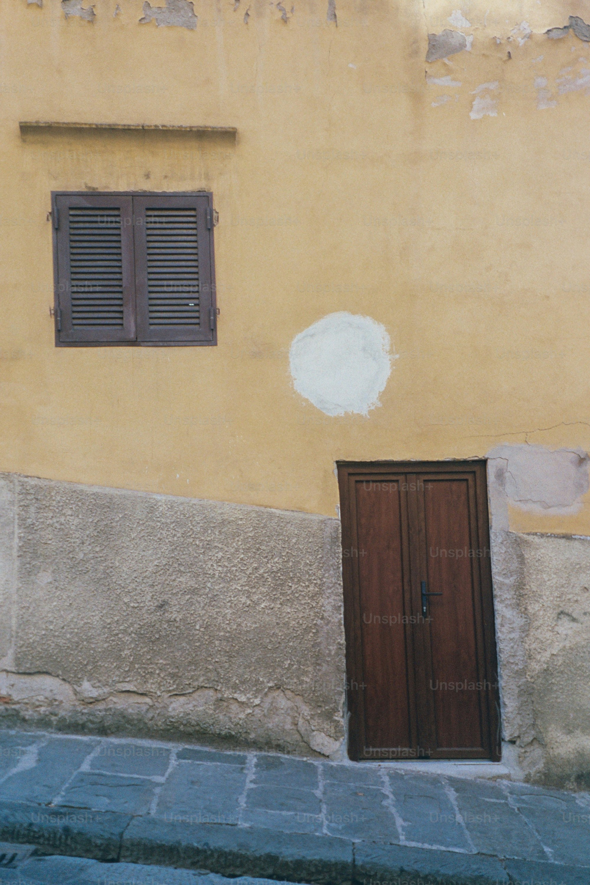 Old building with a window and door.