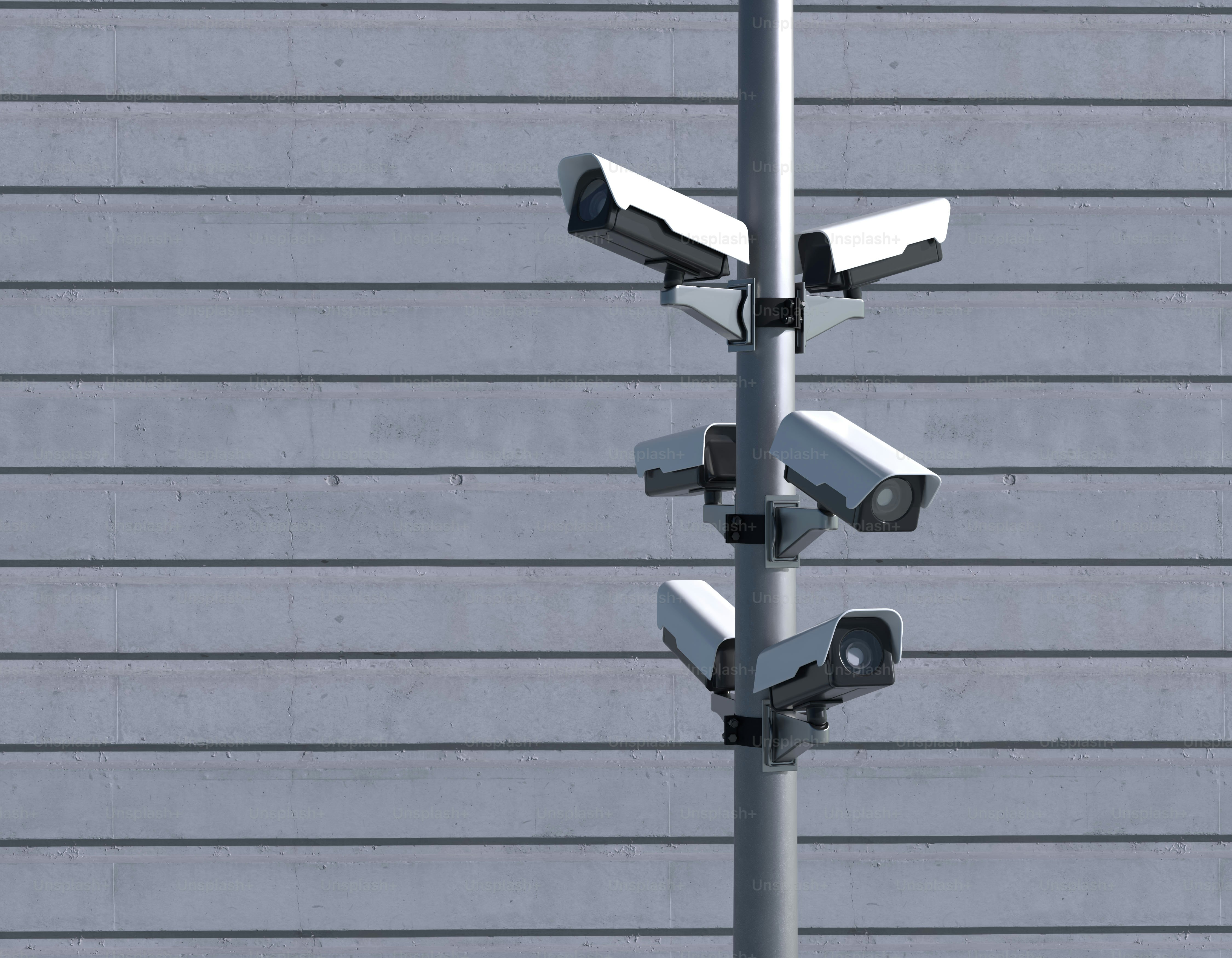 Security cameras on a pole, watching.