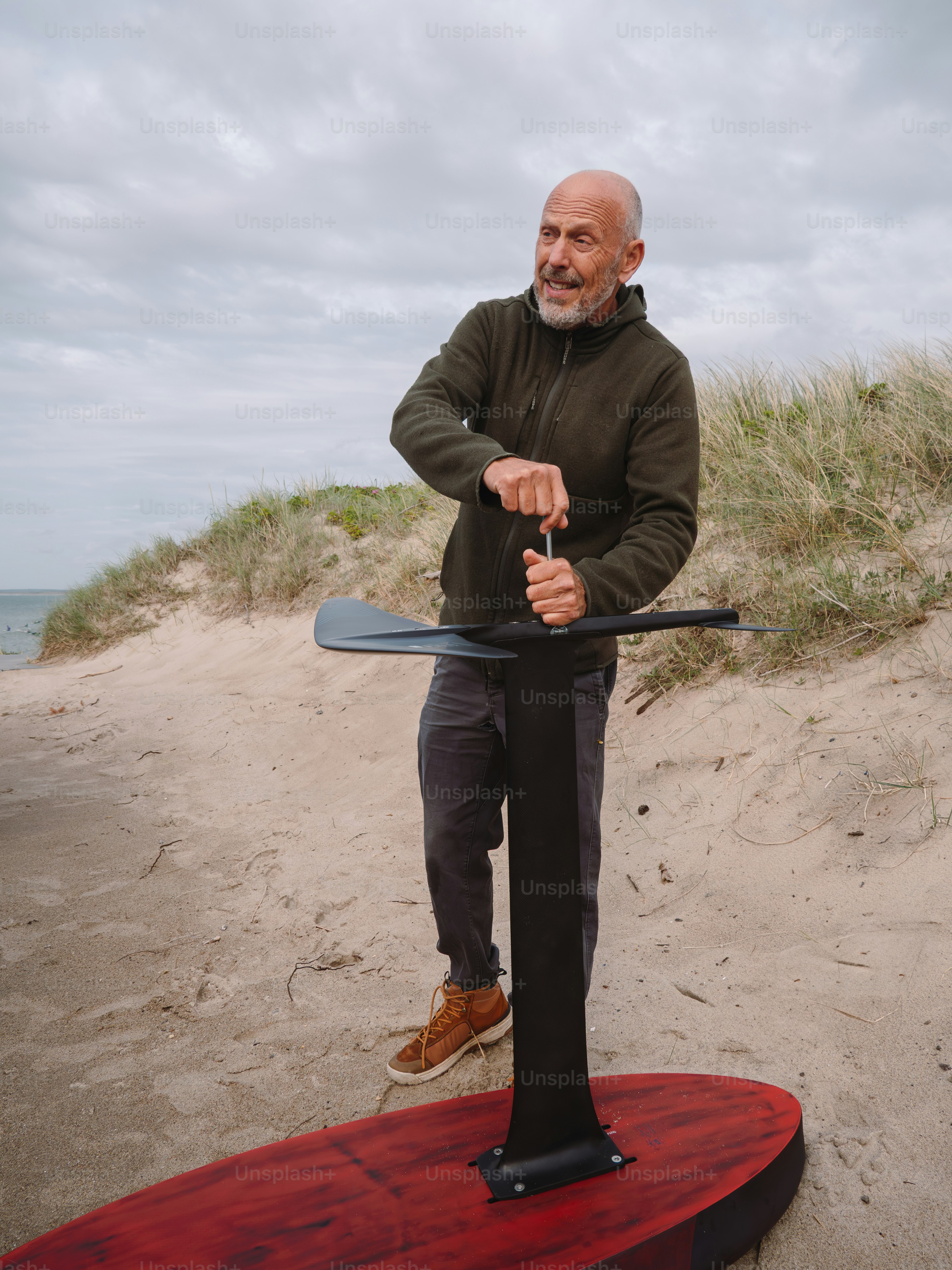 Man prepares a paddleboard at the beach