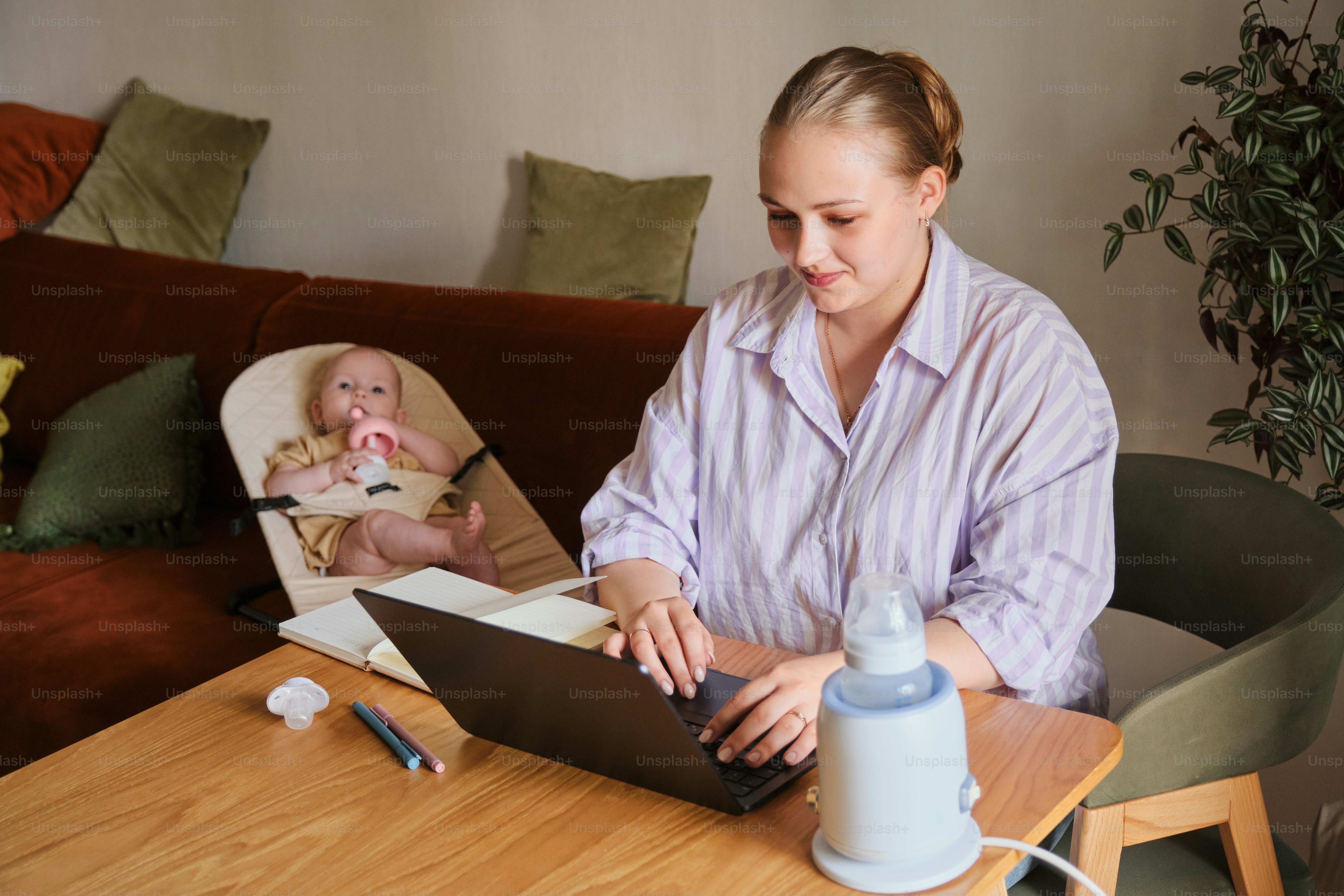 Mom works from home while watching her baby.