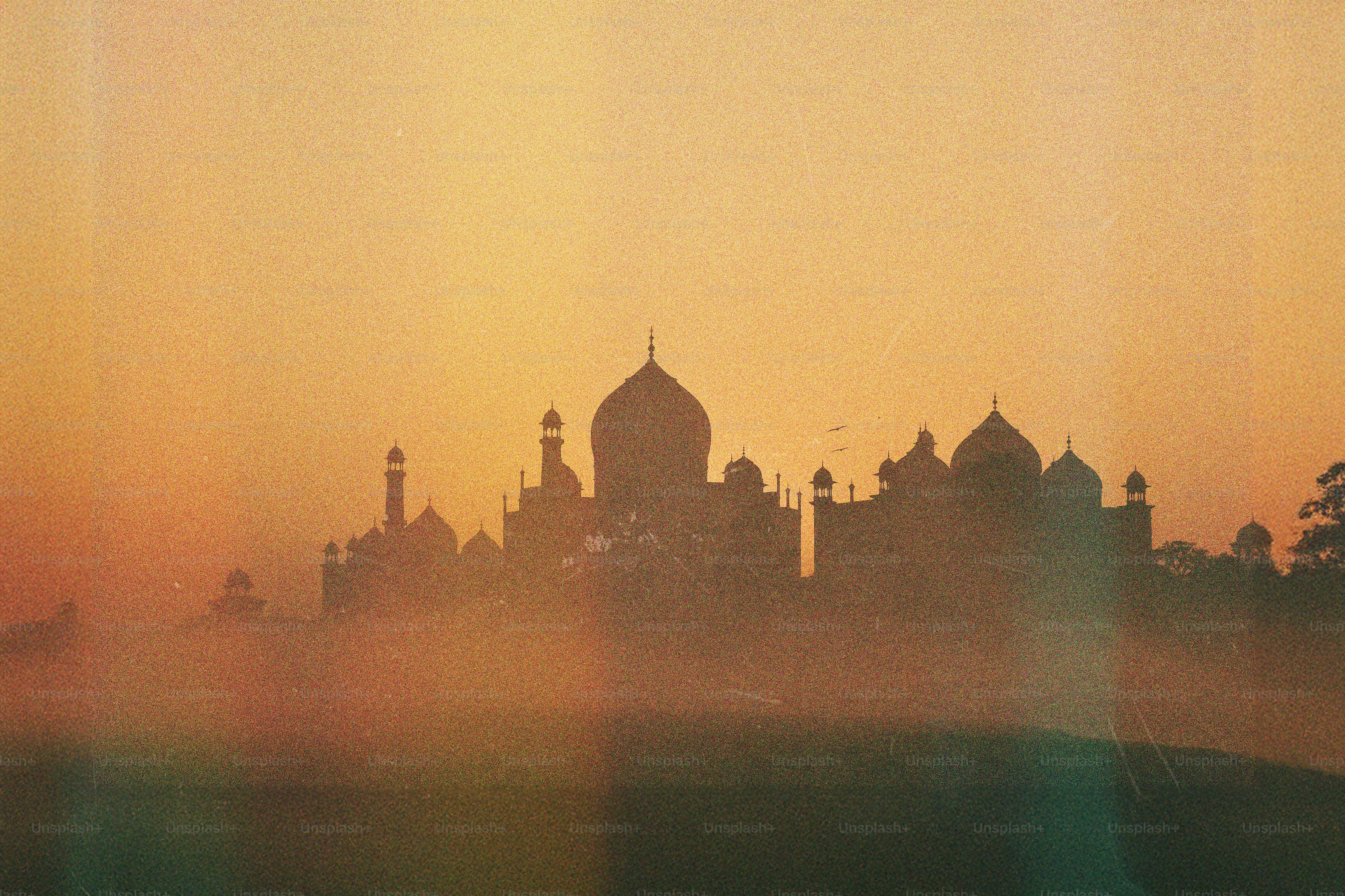 The taj mahal glows in the hazy sunrise. photo – Sunset Image on Unsplash