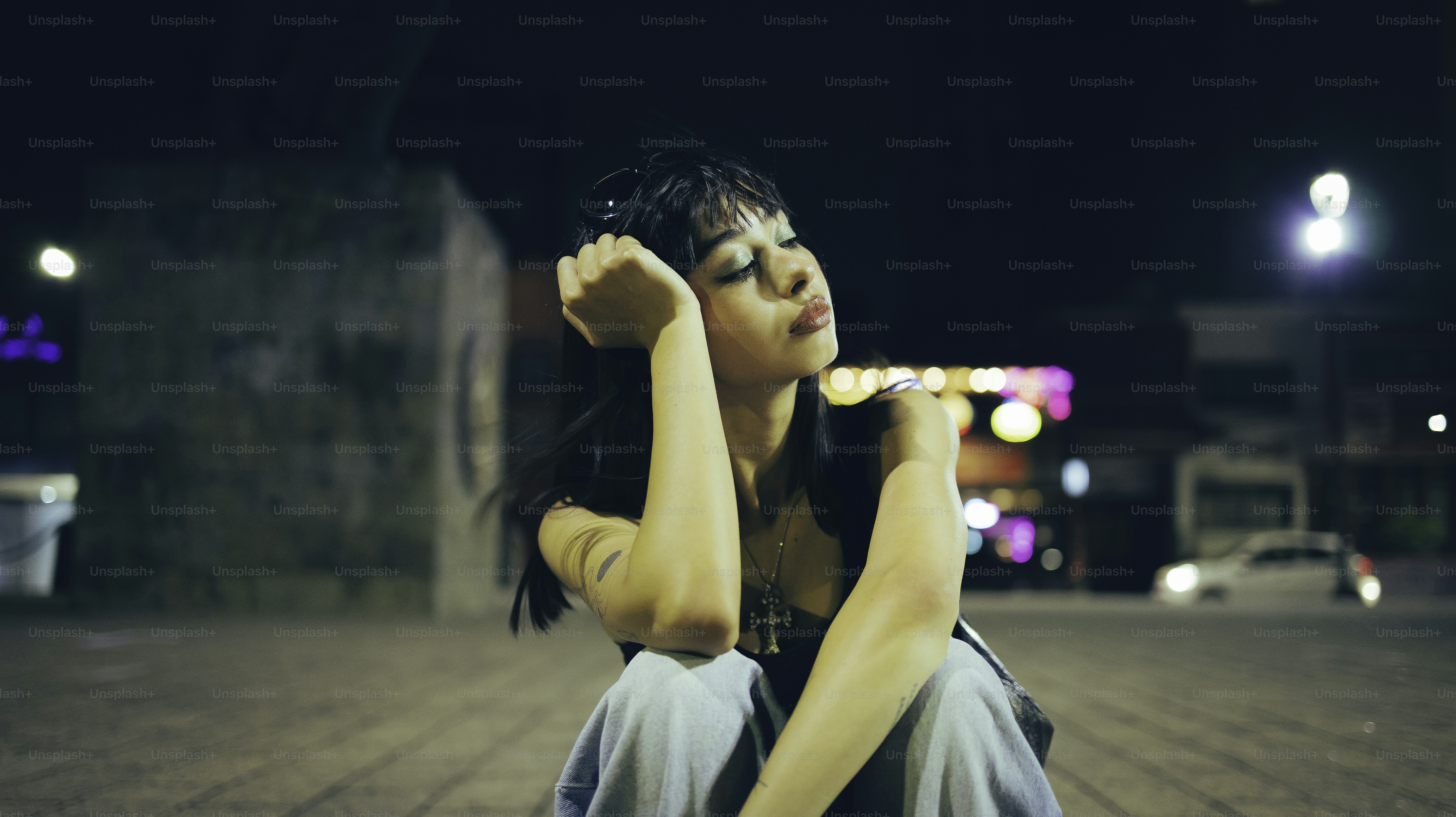 A young woman is posing at night.