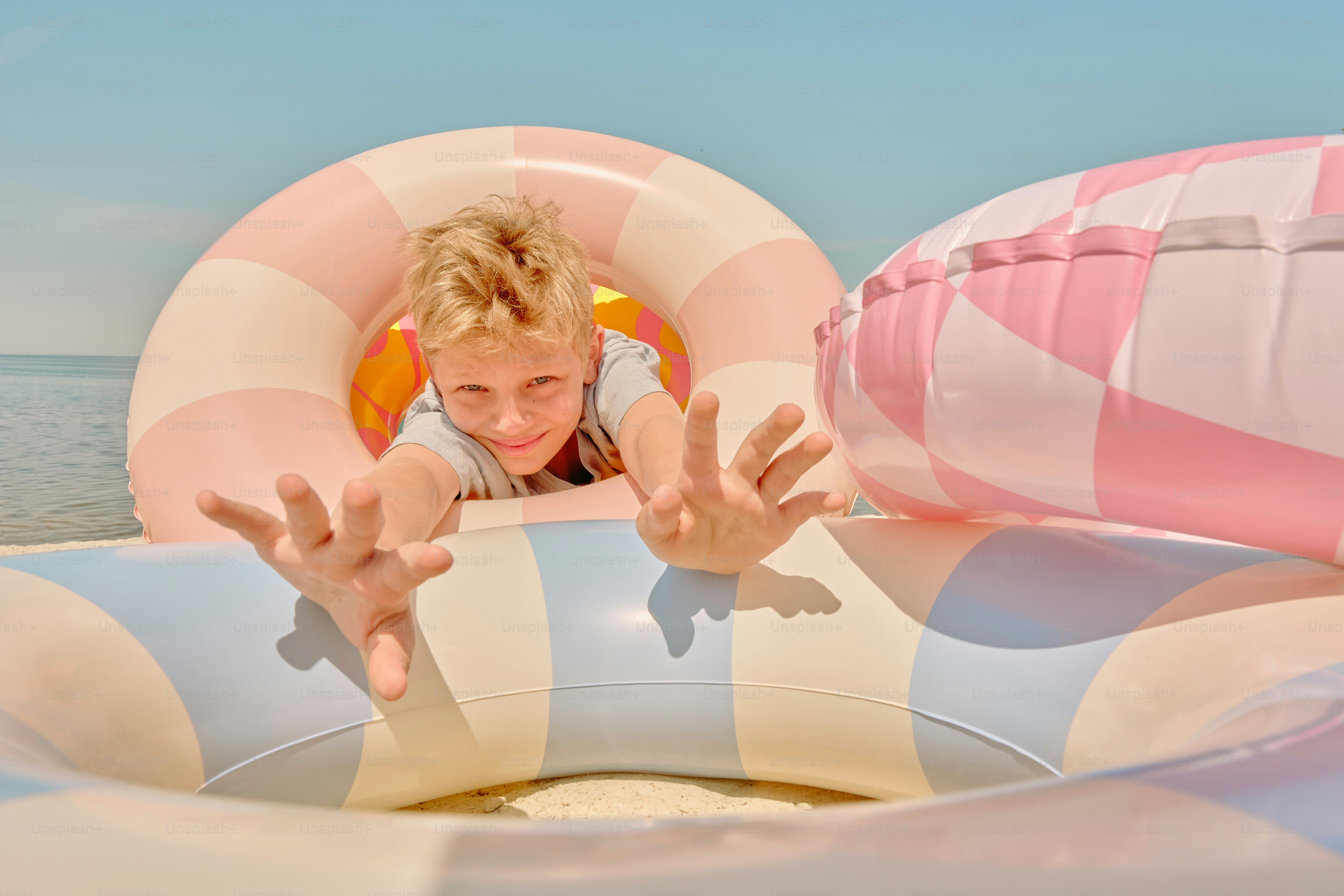 A boy is playing with inflatable rings.