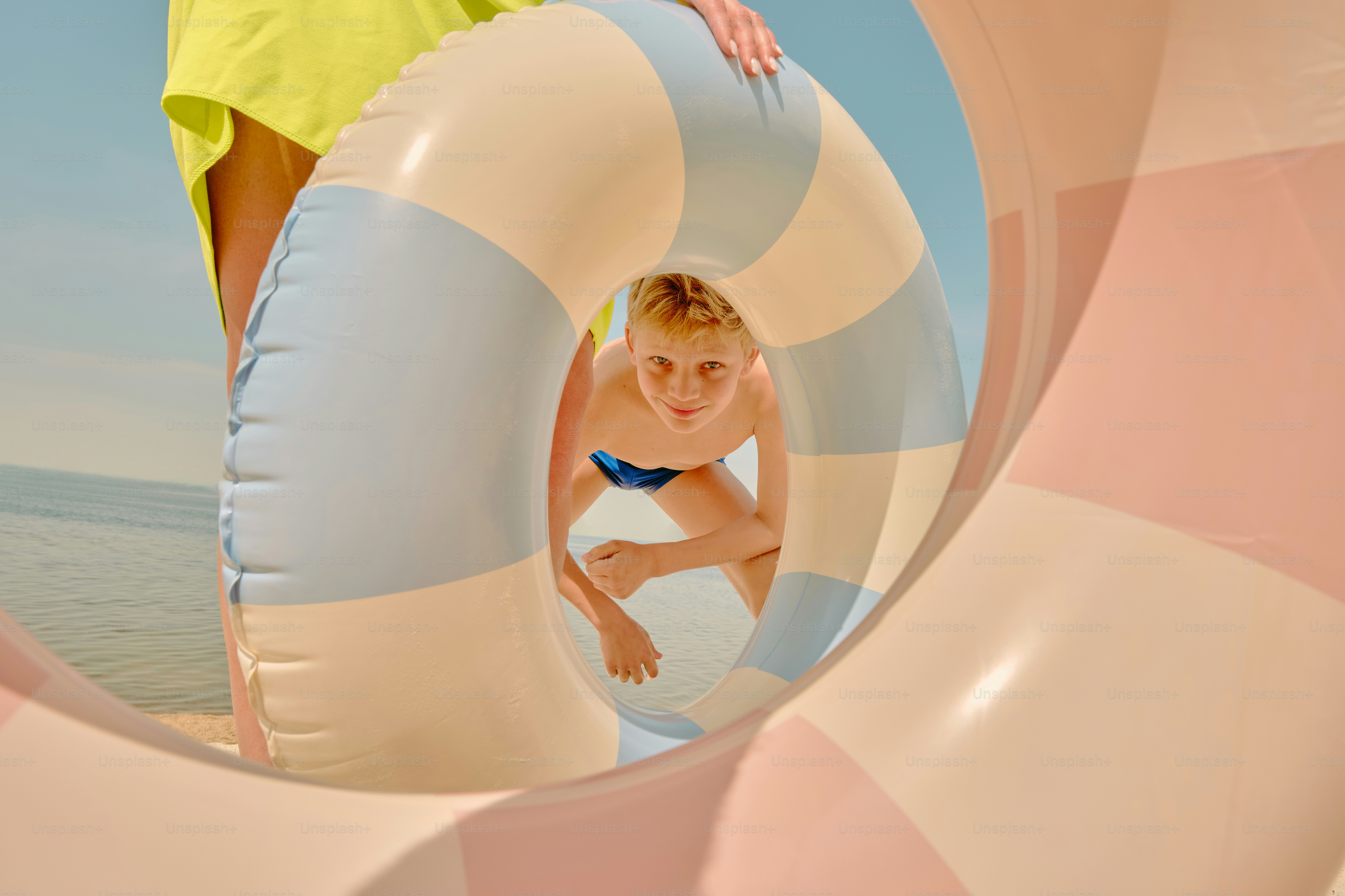 A child looks through an inflatable ring.