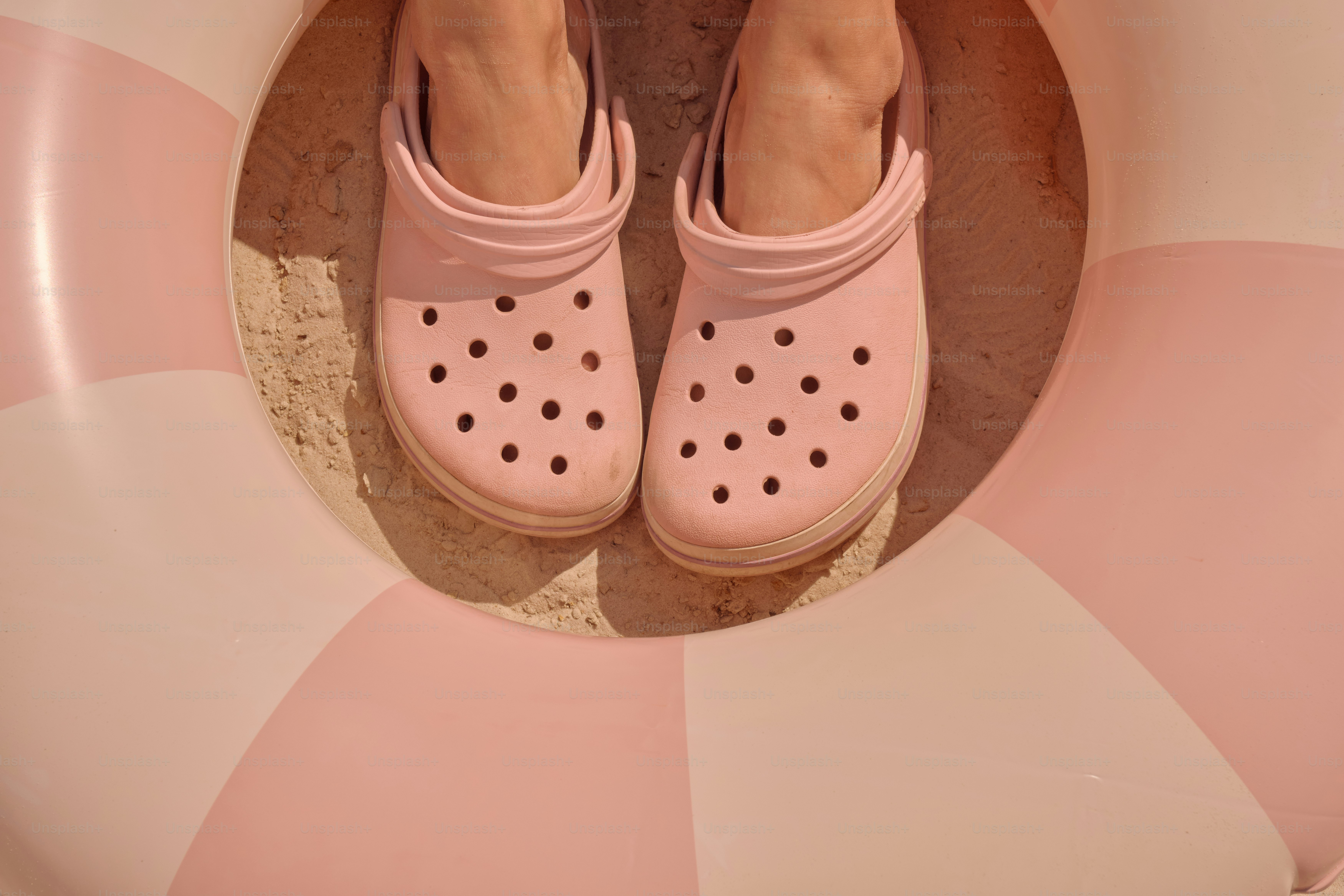 Pink crocs and an inflatable ring.