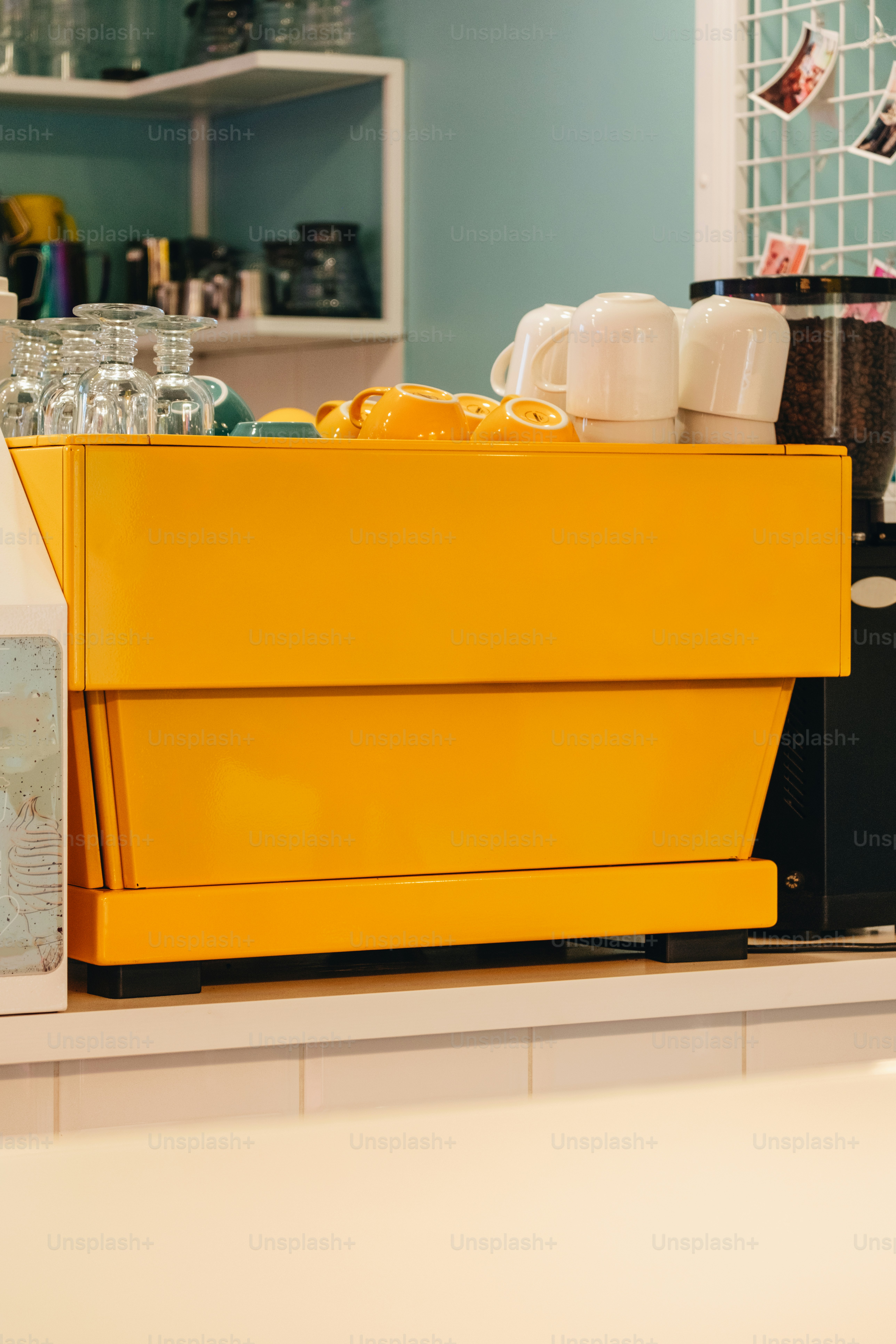 Yellow espresso machine sits on a counter. photo – Interior design ...