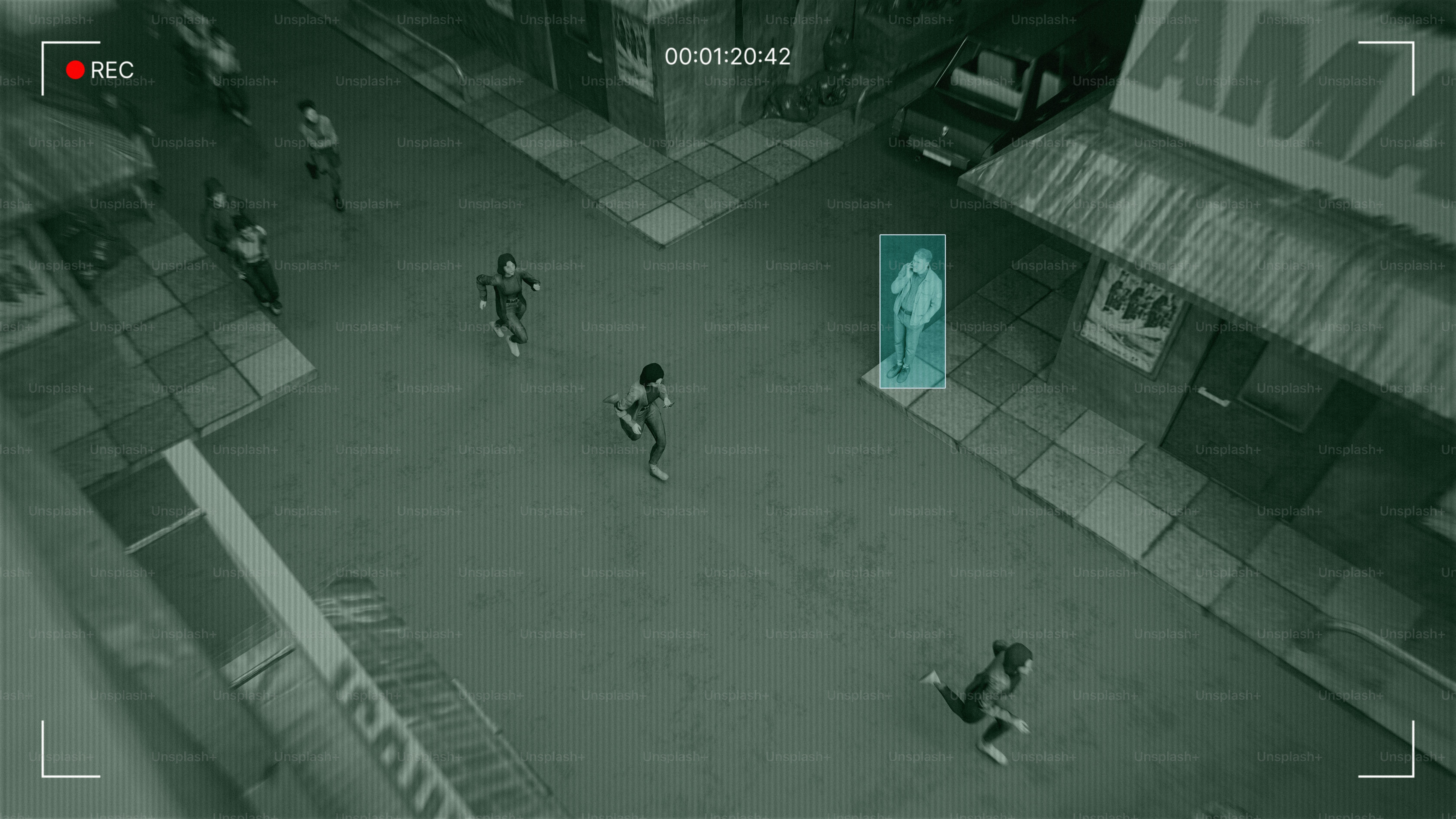 People are running down a street under surveillance.