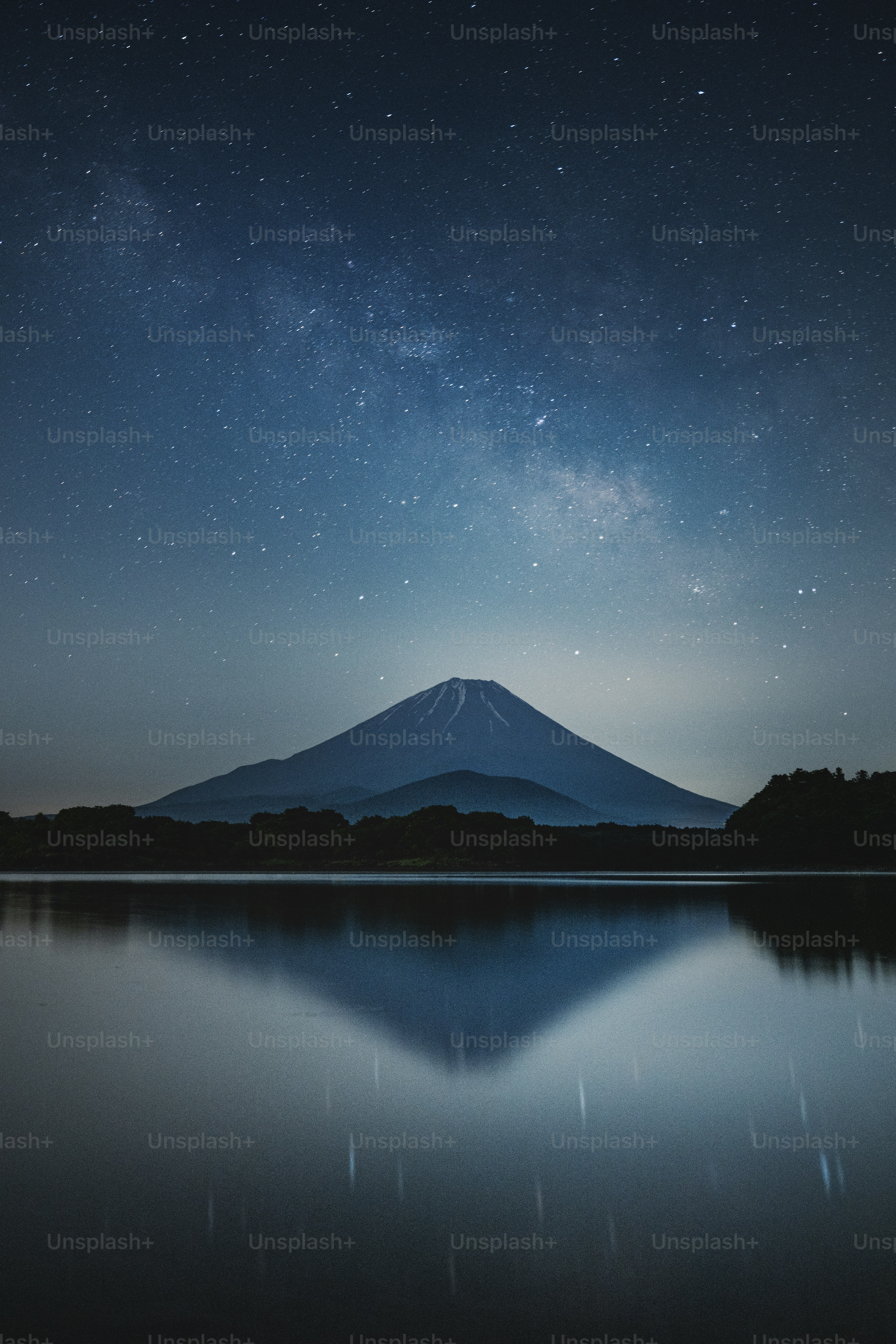 Mount fuji reflects under a stunning milky way.