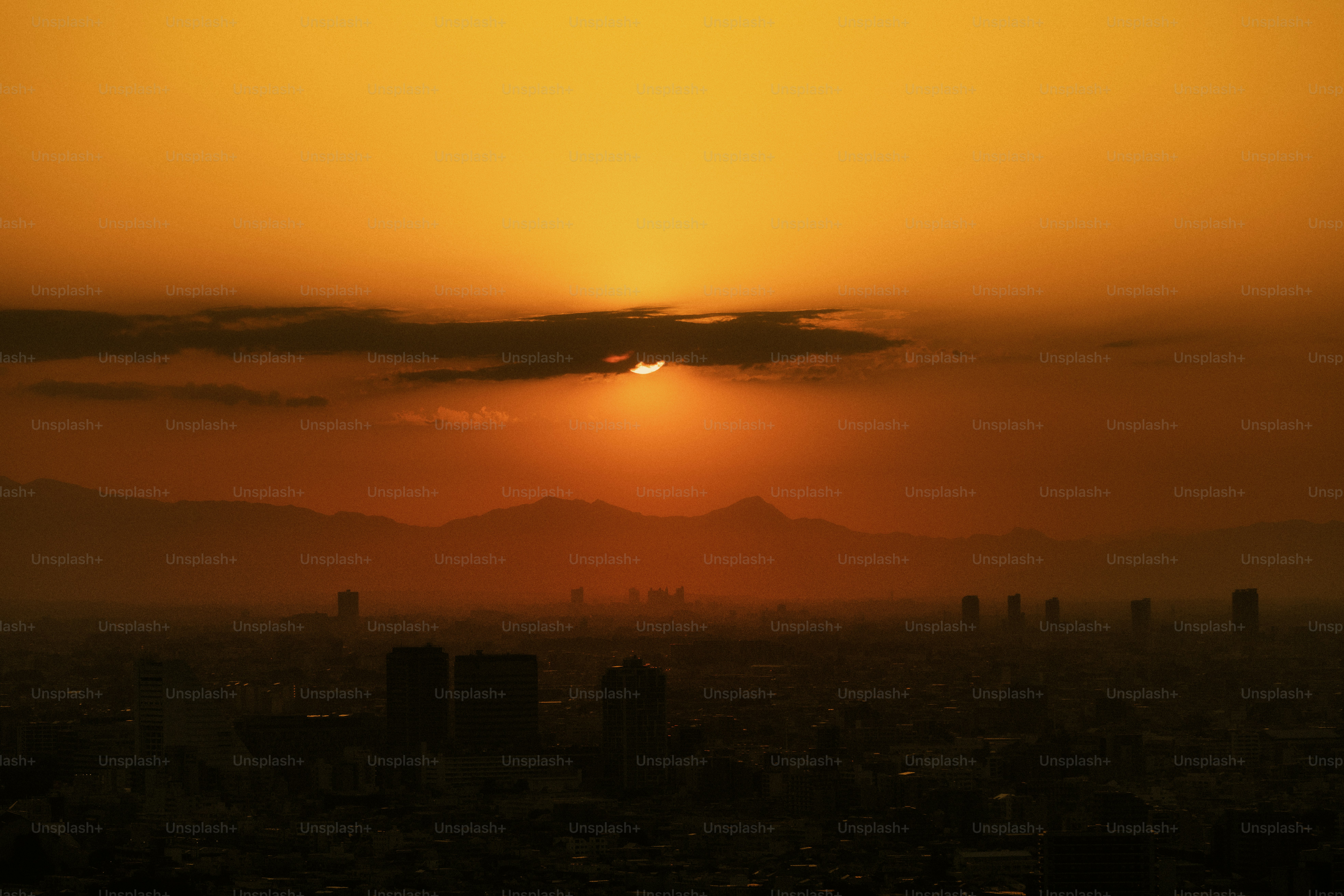 Sunset casts a golden glow over the distant city.