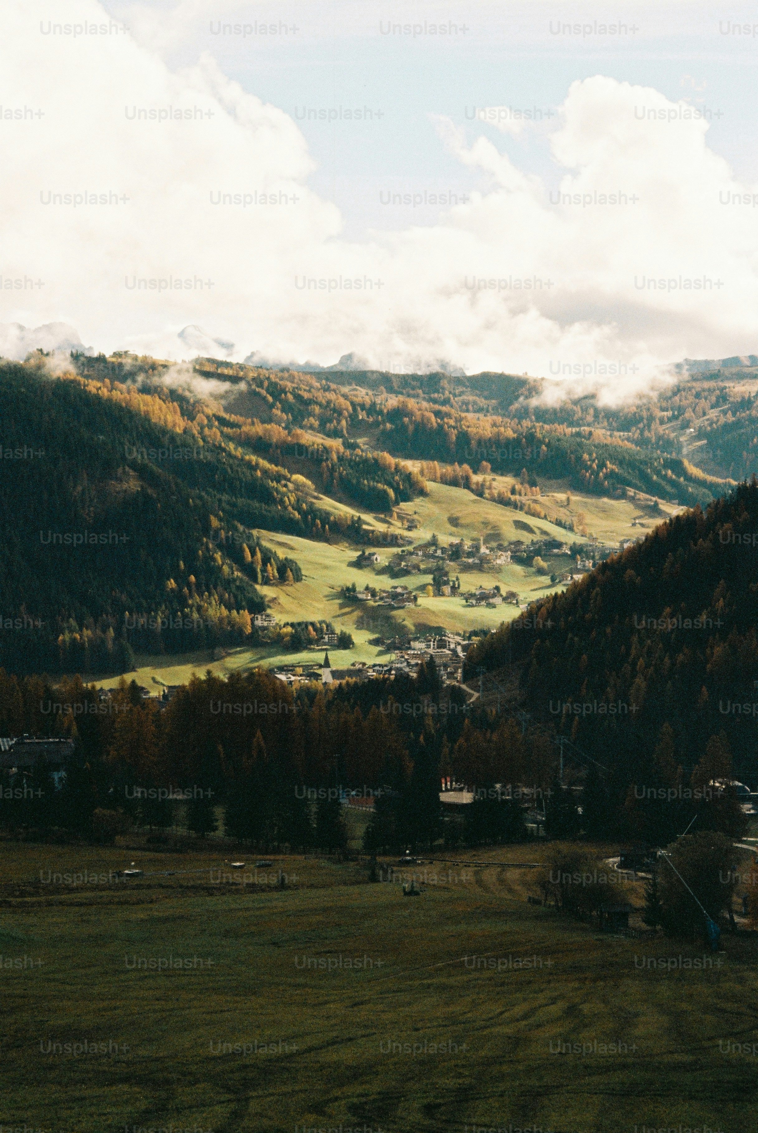Rolling hills and a village bathed in sunlight.