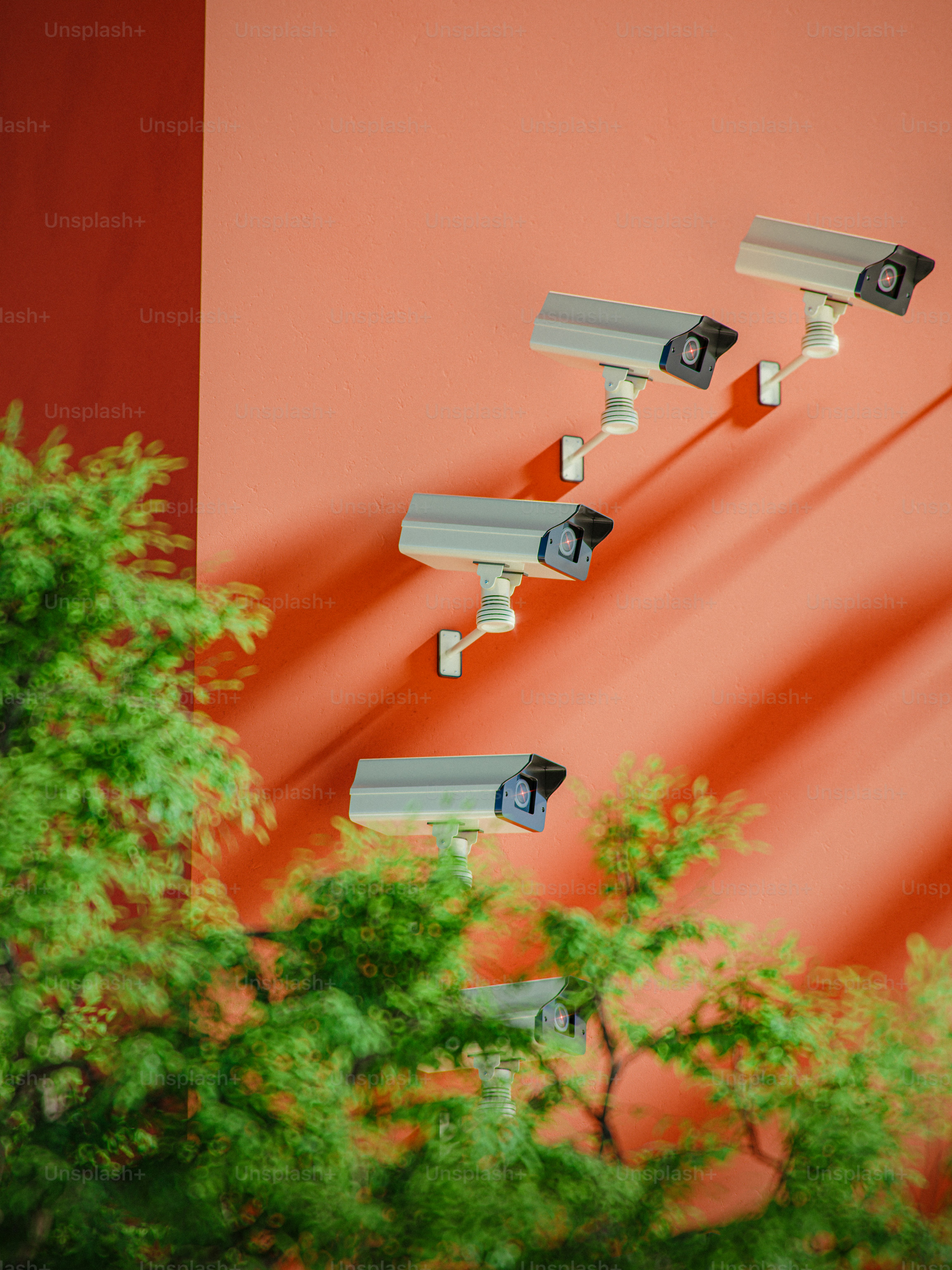Surveillance cameras watch over a colorful wall.