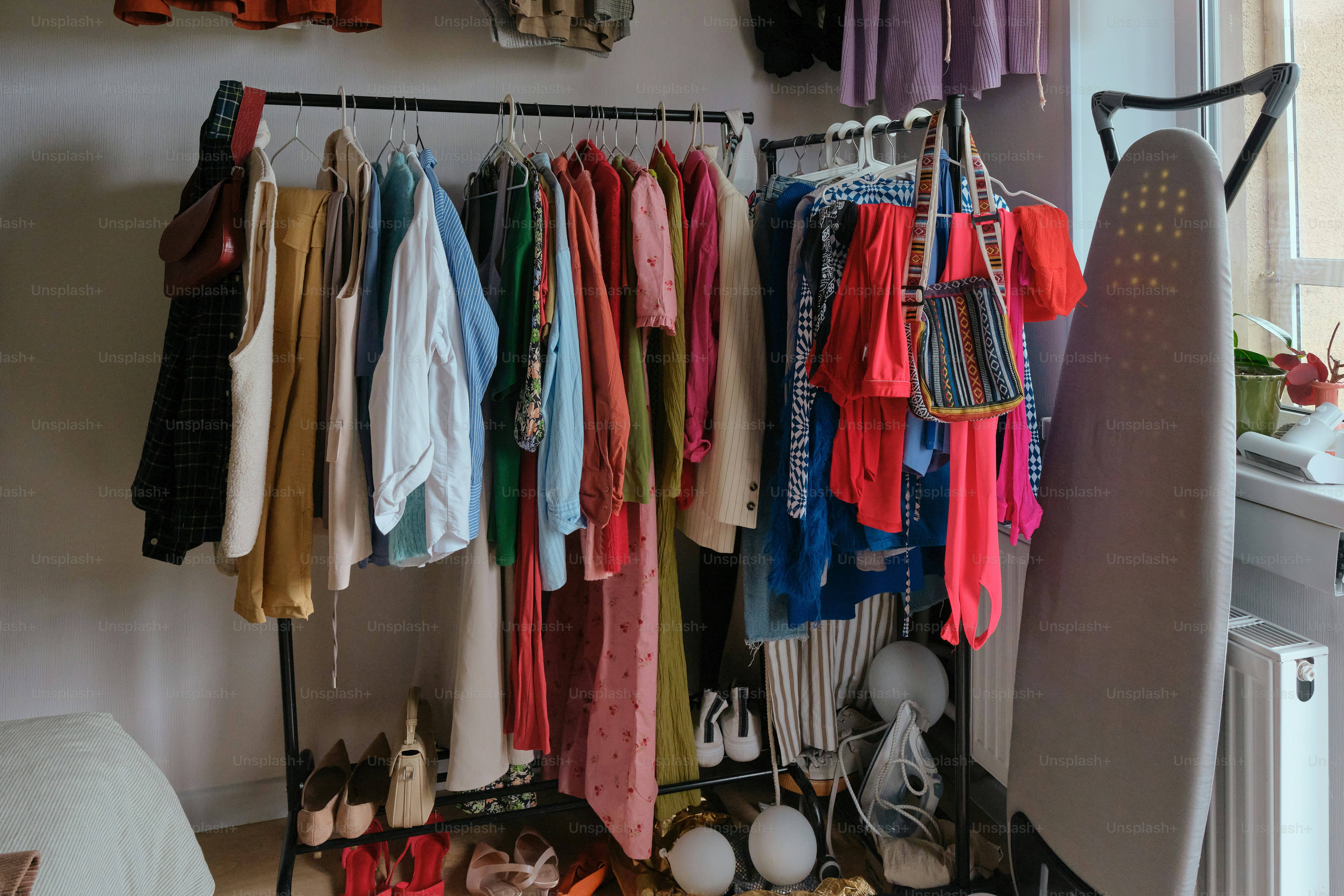 Clothes are neatly organized on a clothing rack.