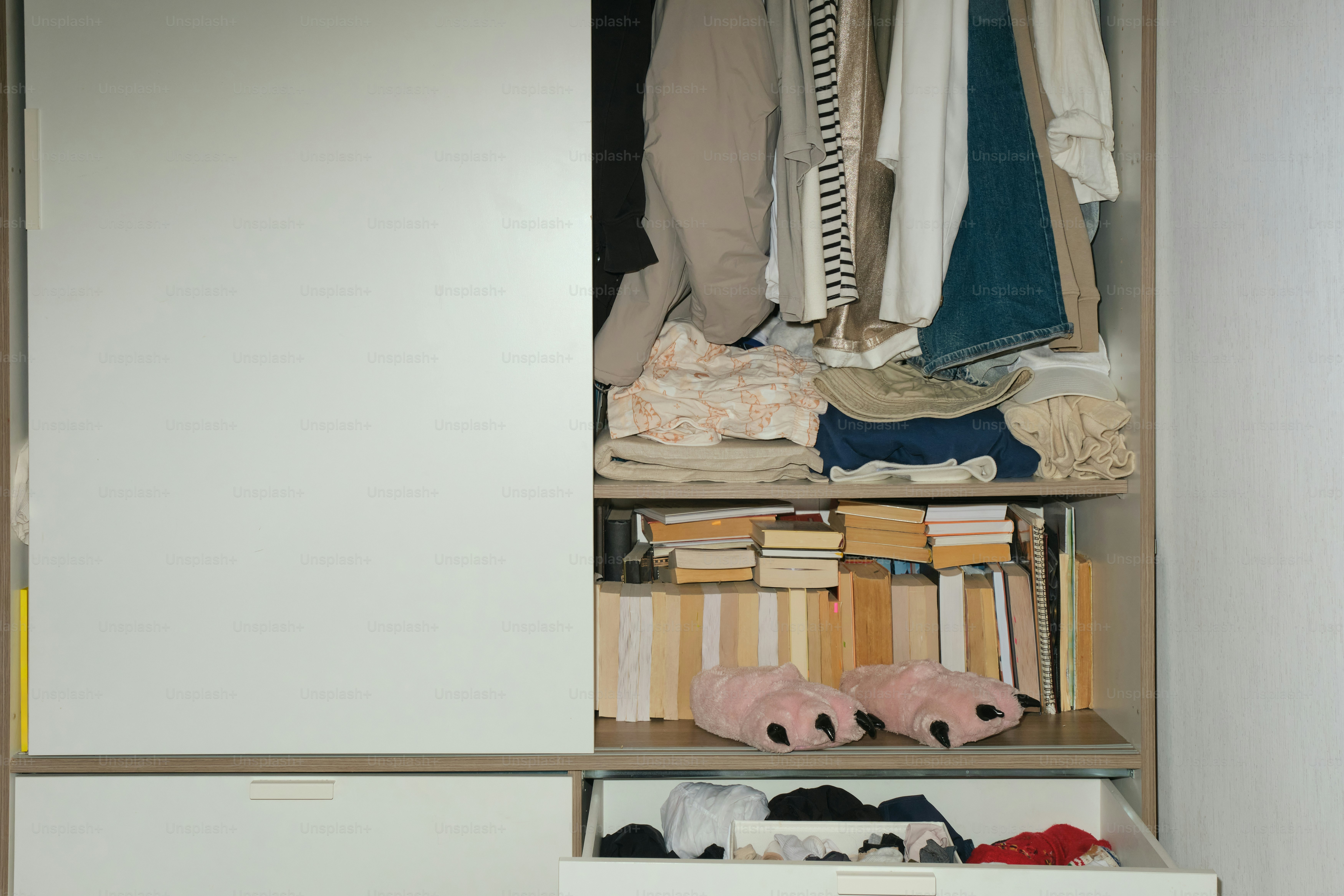 Clothes, shoes and accessories stored inside a closet.