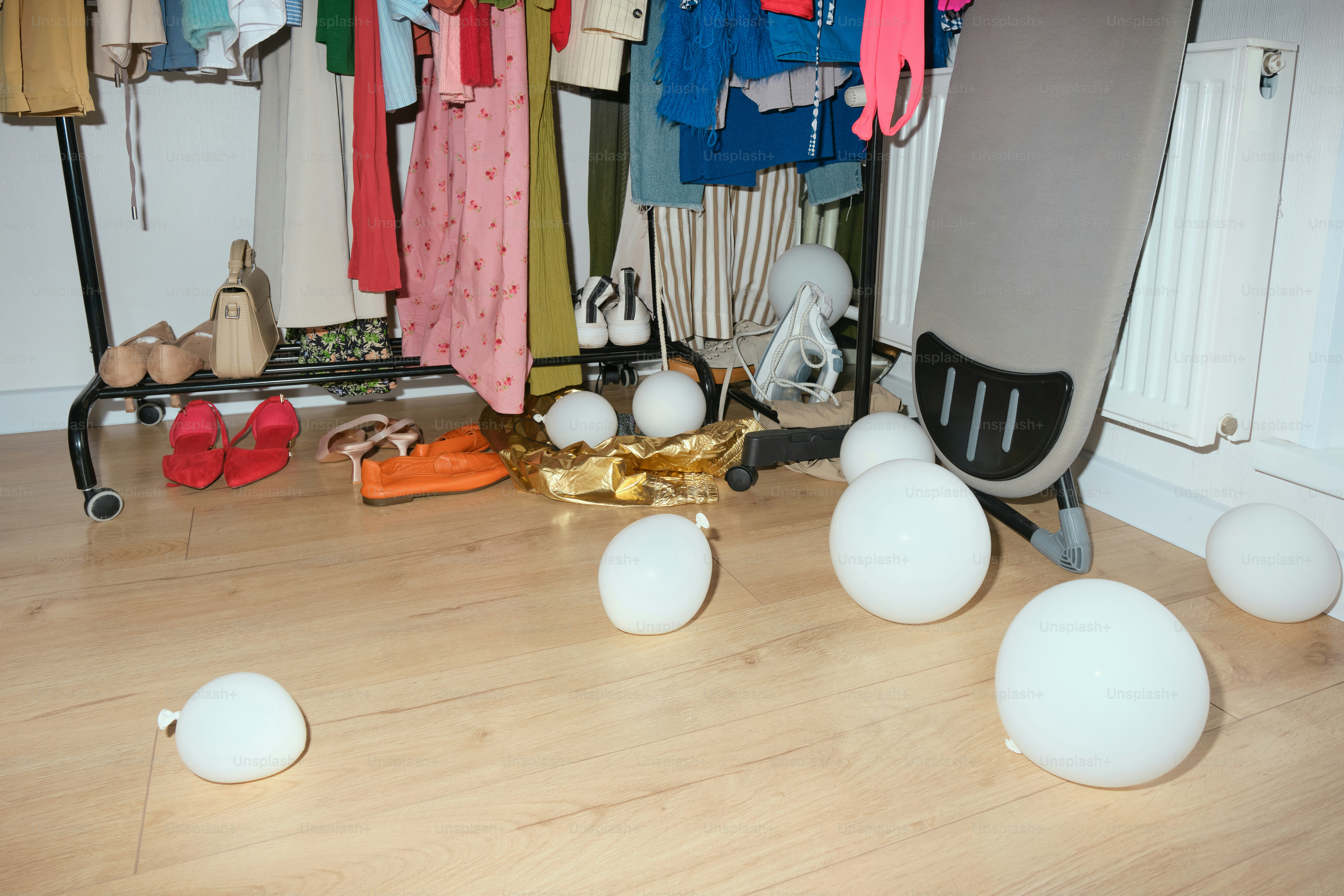 Clothes, balloons, and an office chair are visible.