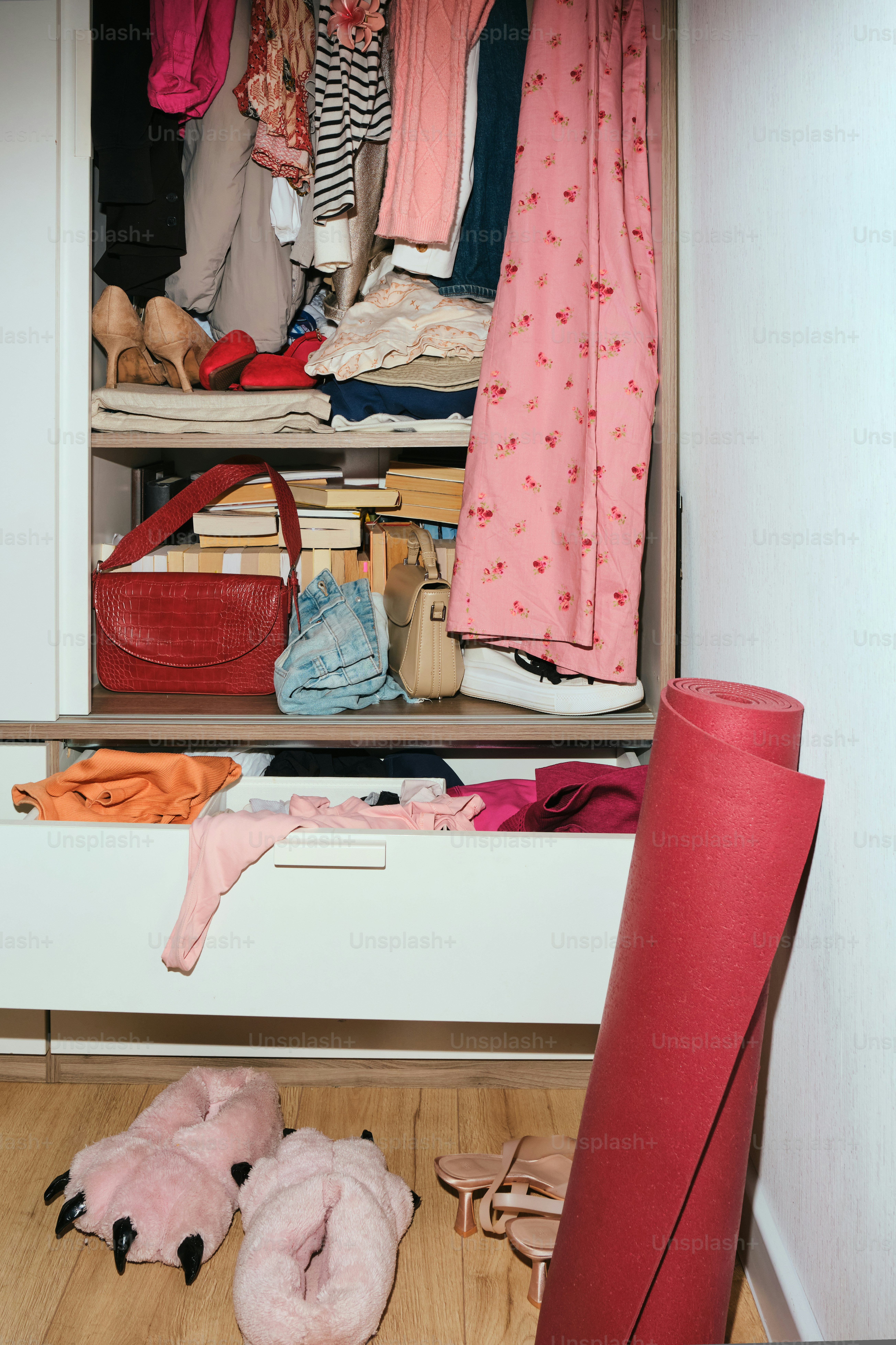 A cluttered closet with clothes and accessories.