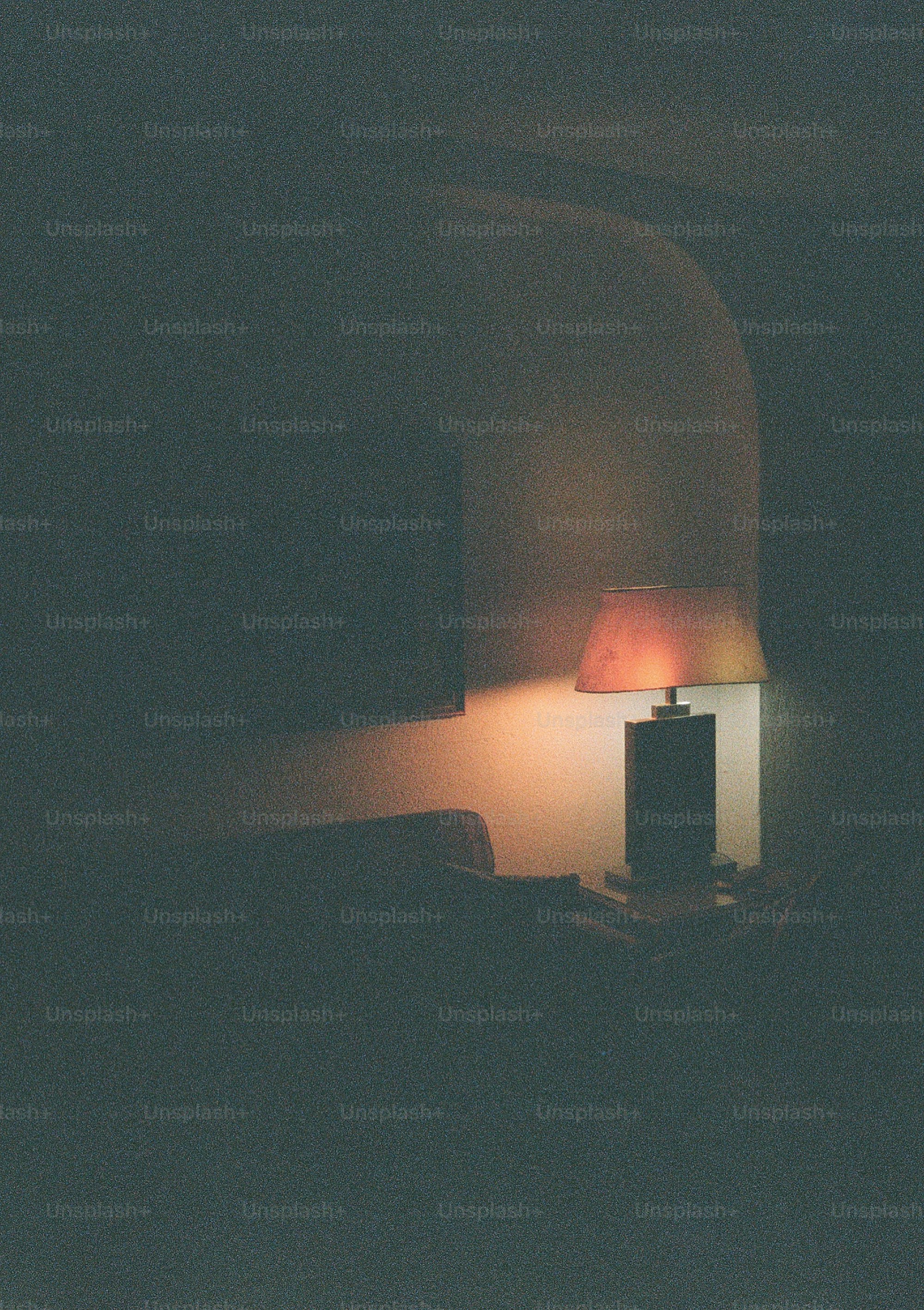 A lamp illuminates a dark room.