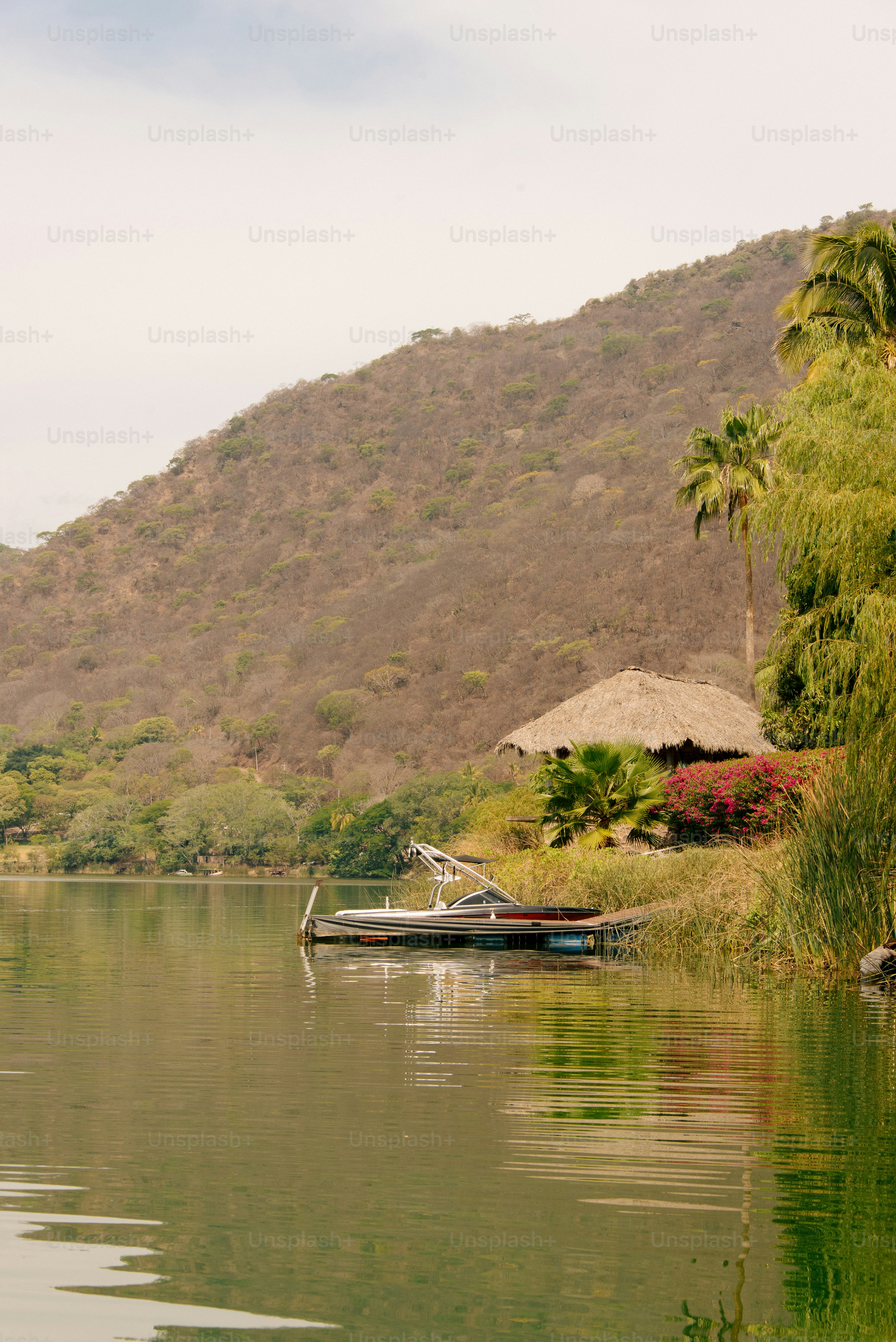 A serene lake scene with mountain and dock.
