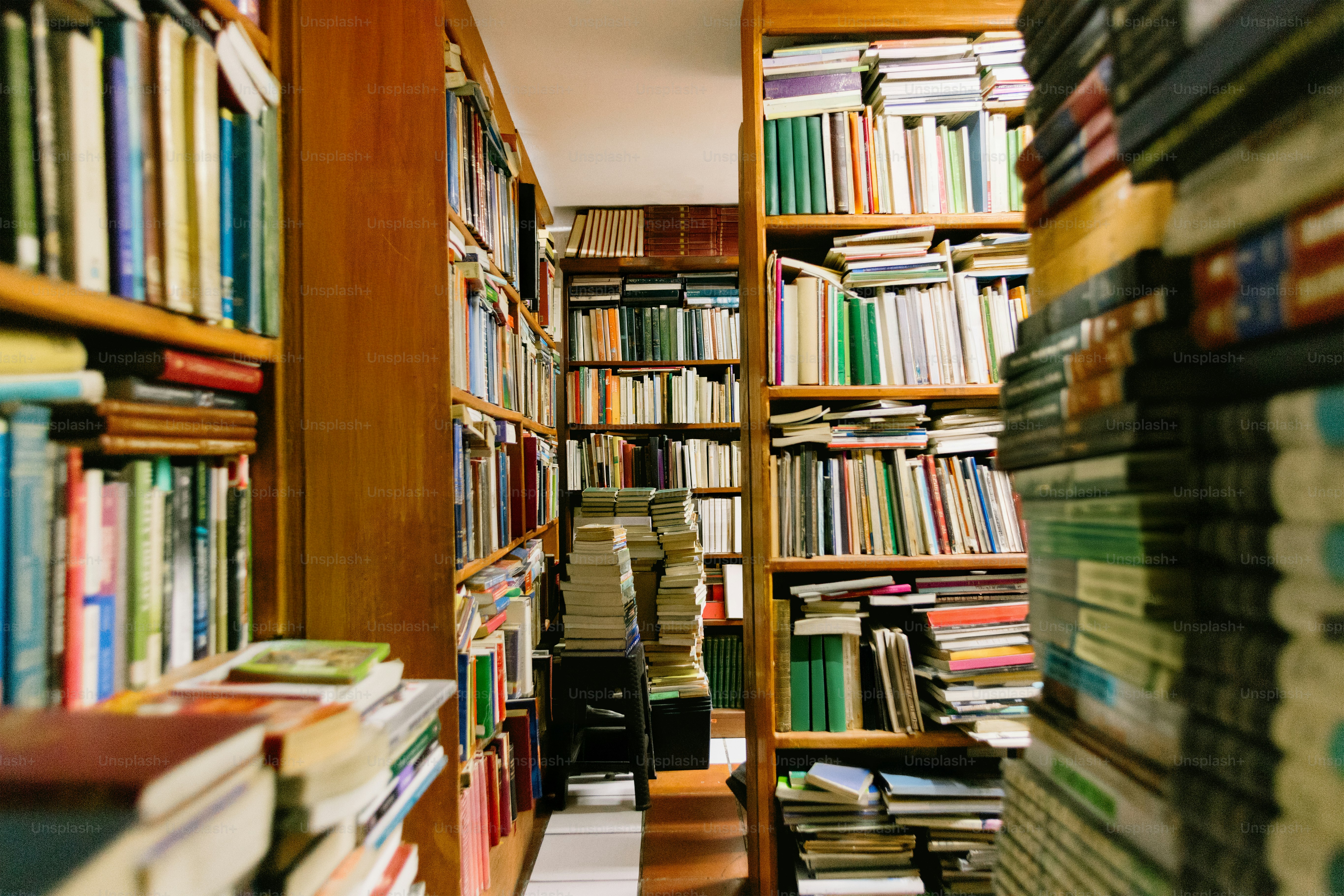 Bookshelves overflowing with books in a library.