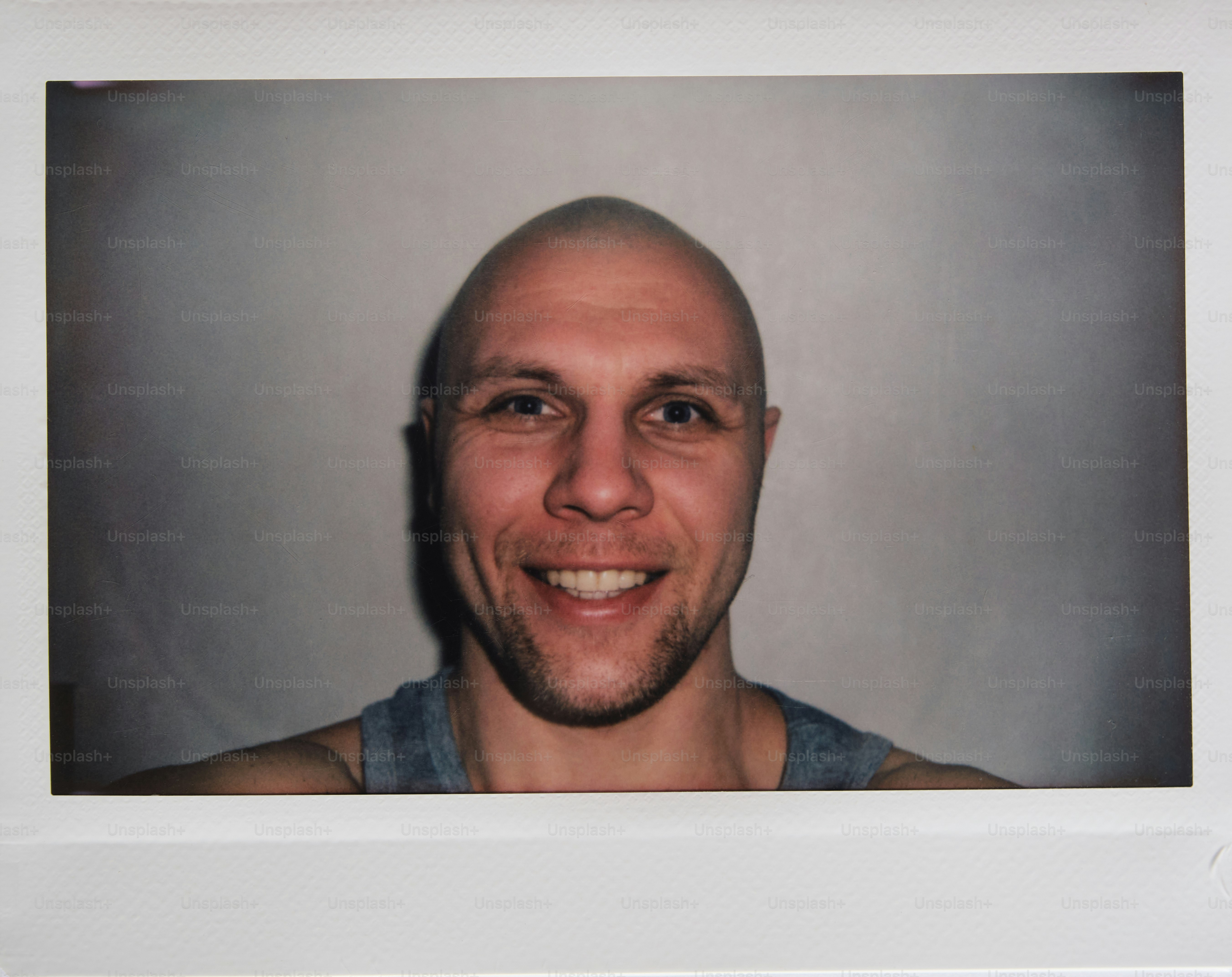 Smiling man poses for a portrait with a white background.