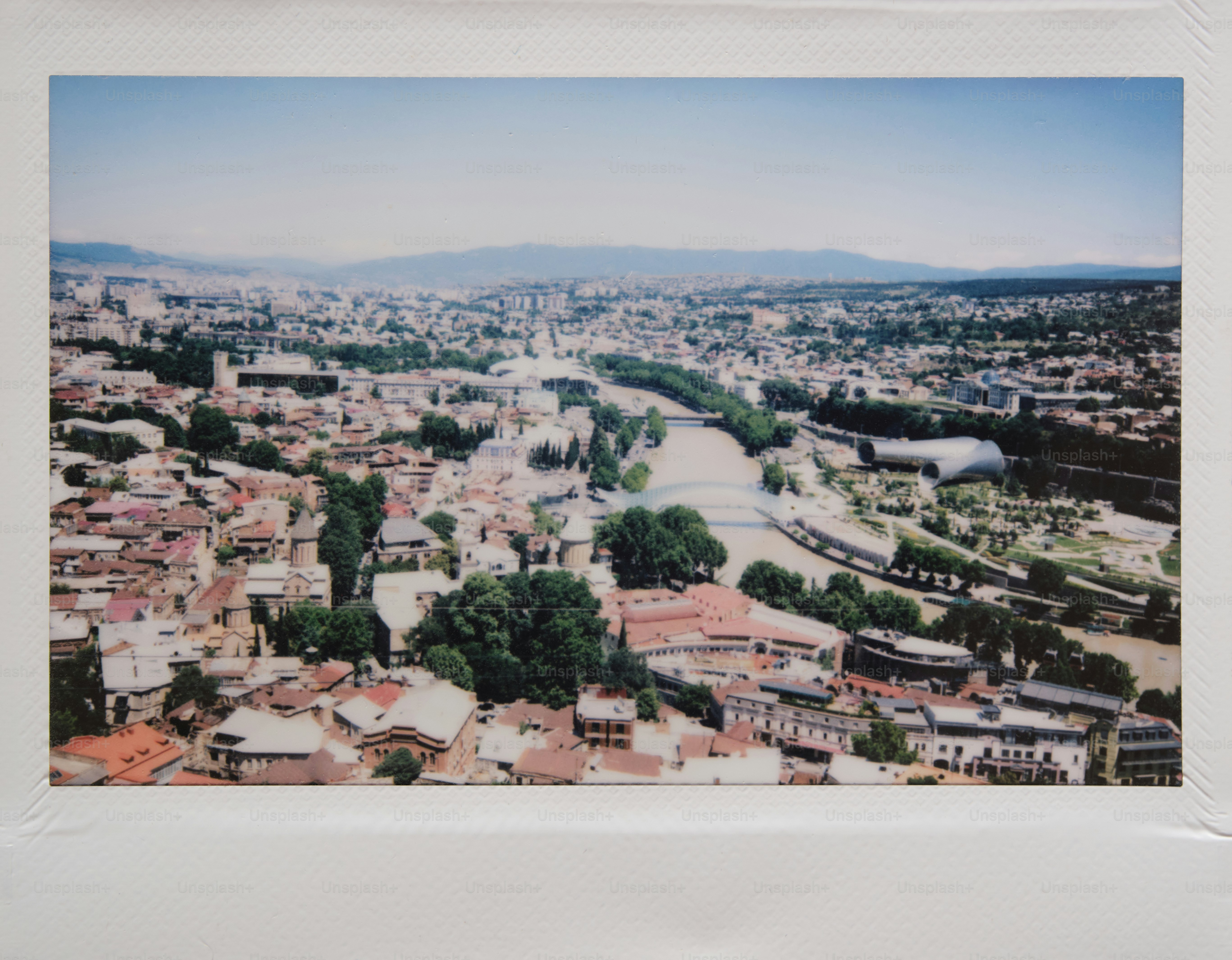 Aerial view of a city, with a river.