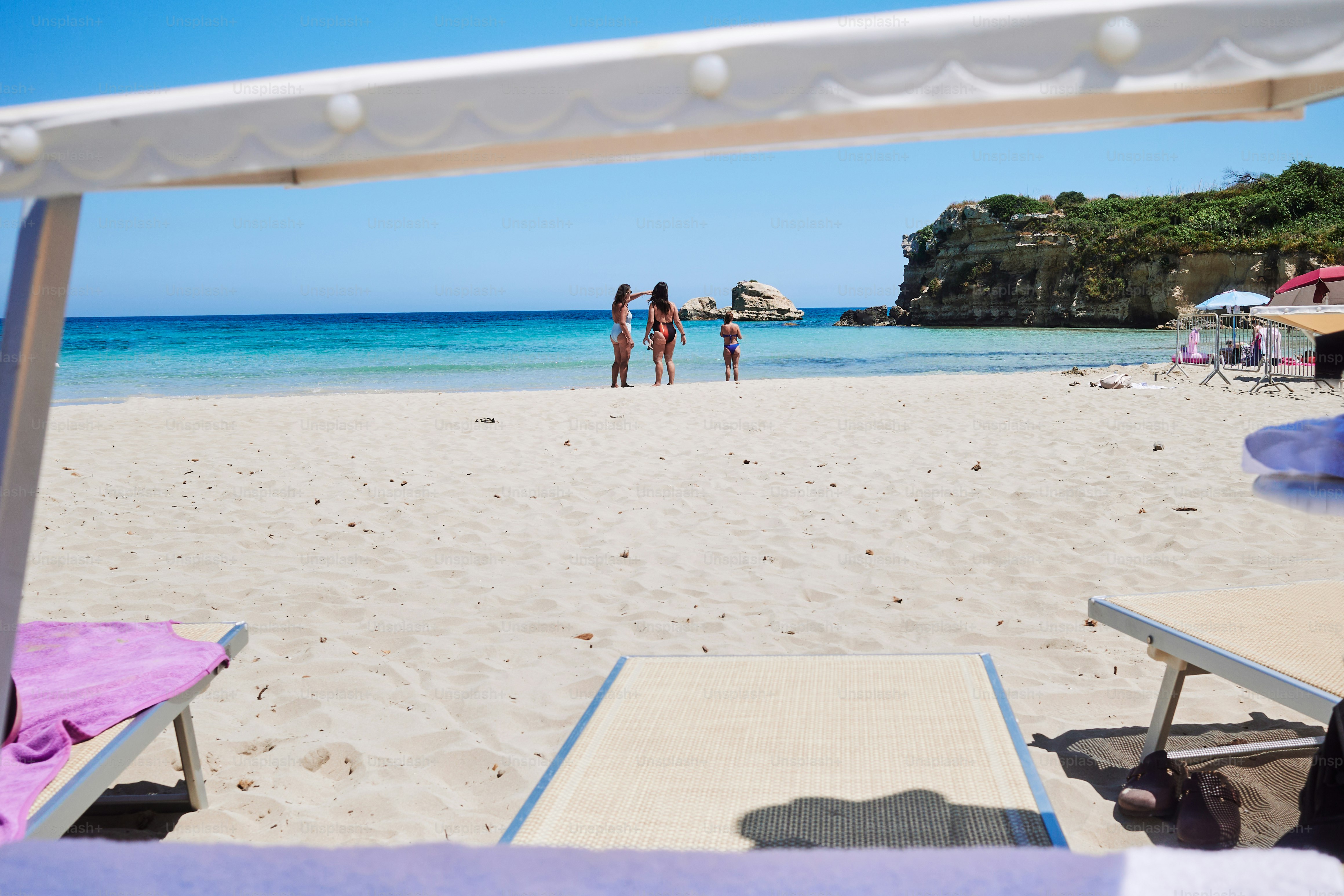 People are enjoying a beautiful beach on a sunny day.
