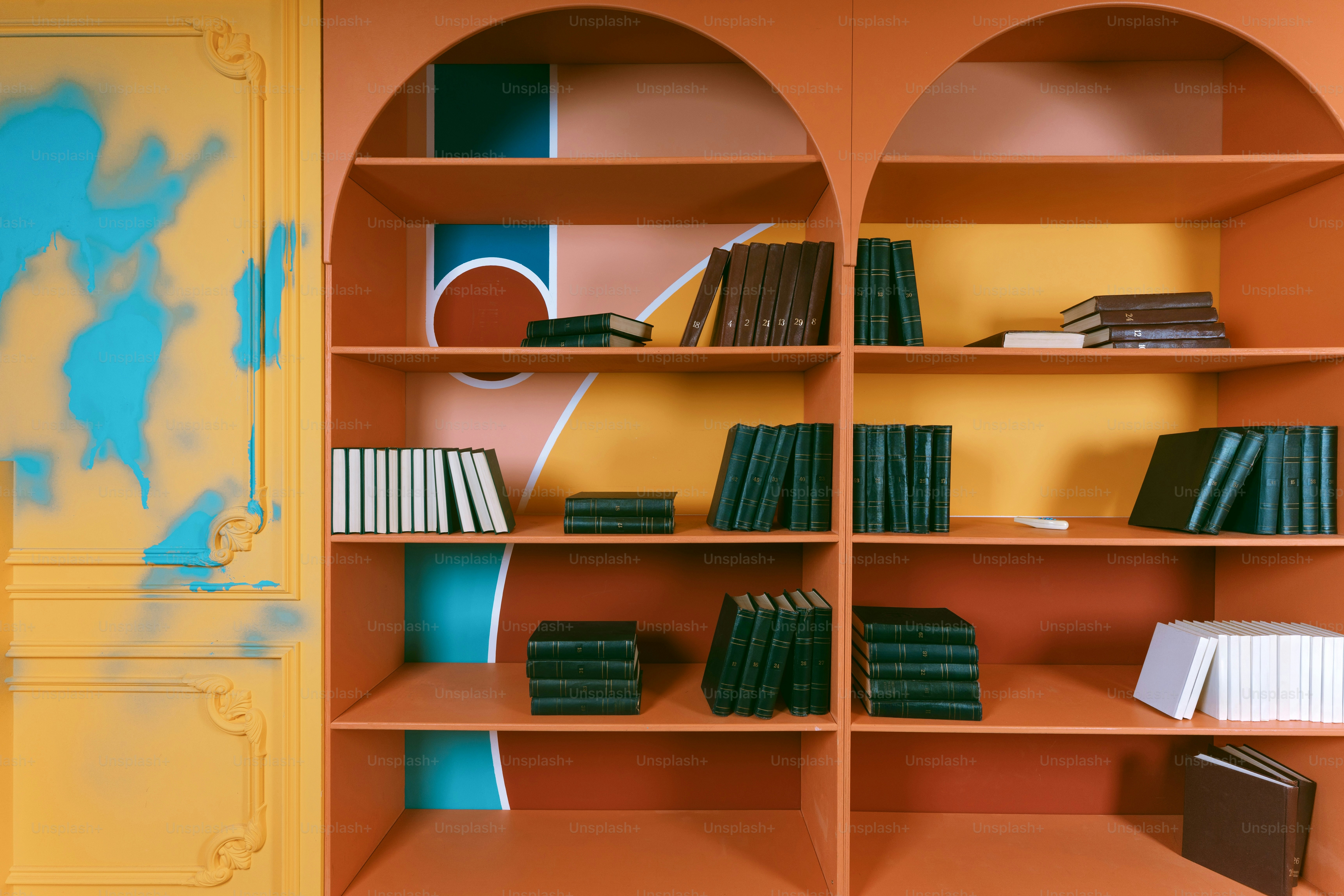 Orange bookshelf with colorful geometric shapes and books.
