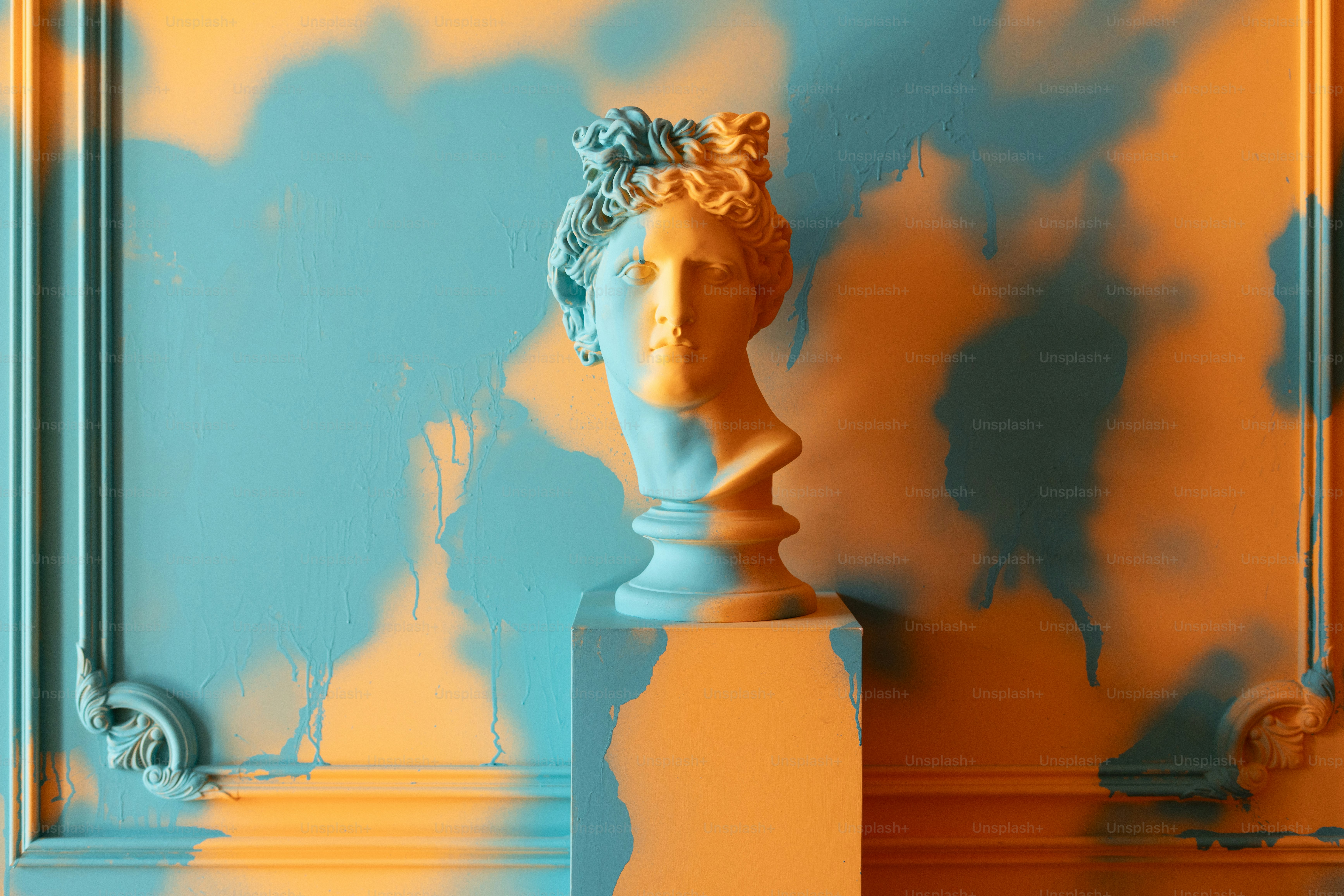 Statue basks in colorful and dramatic lighting.