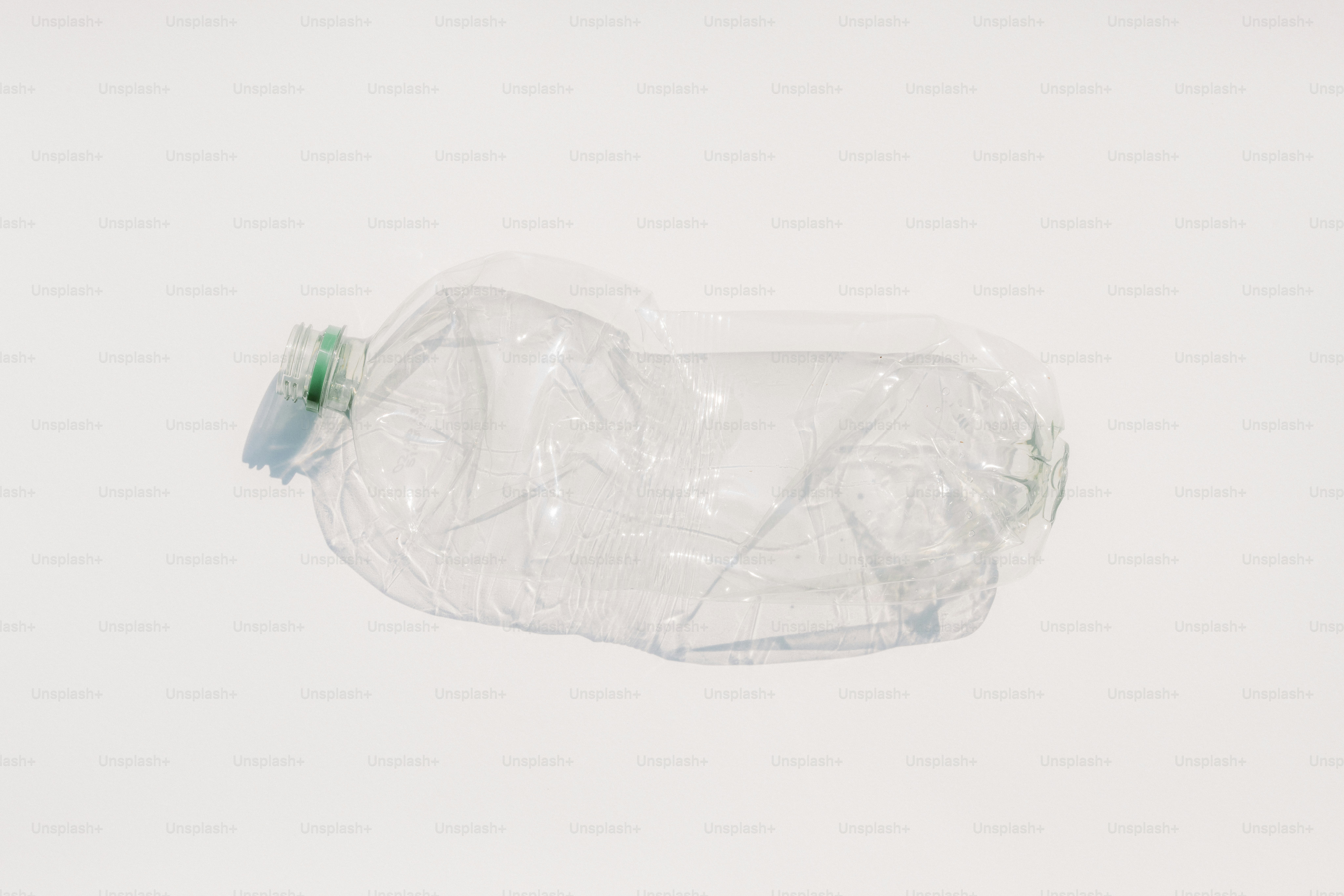 A crushed plastic water bottle on a white background.