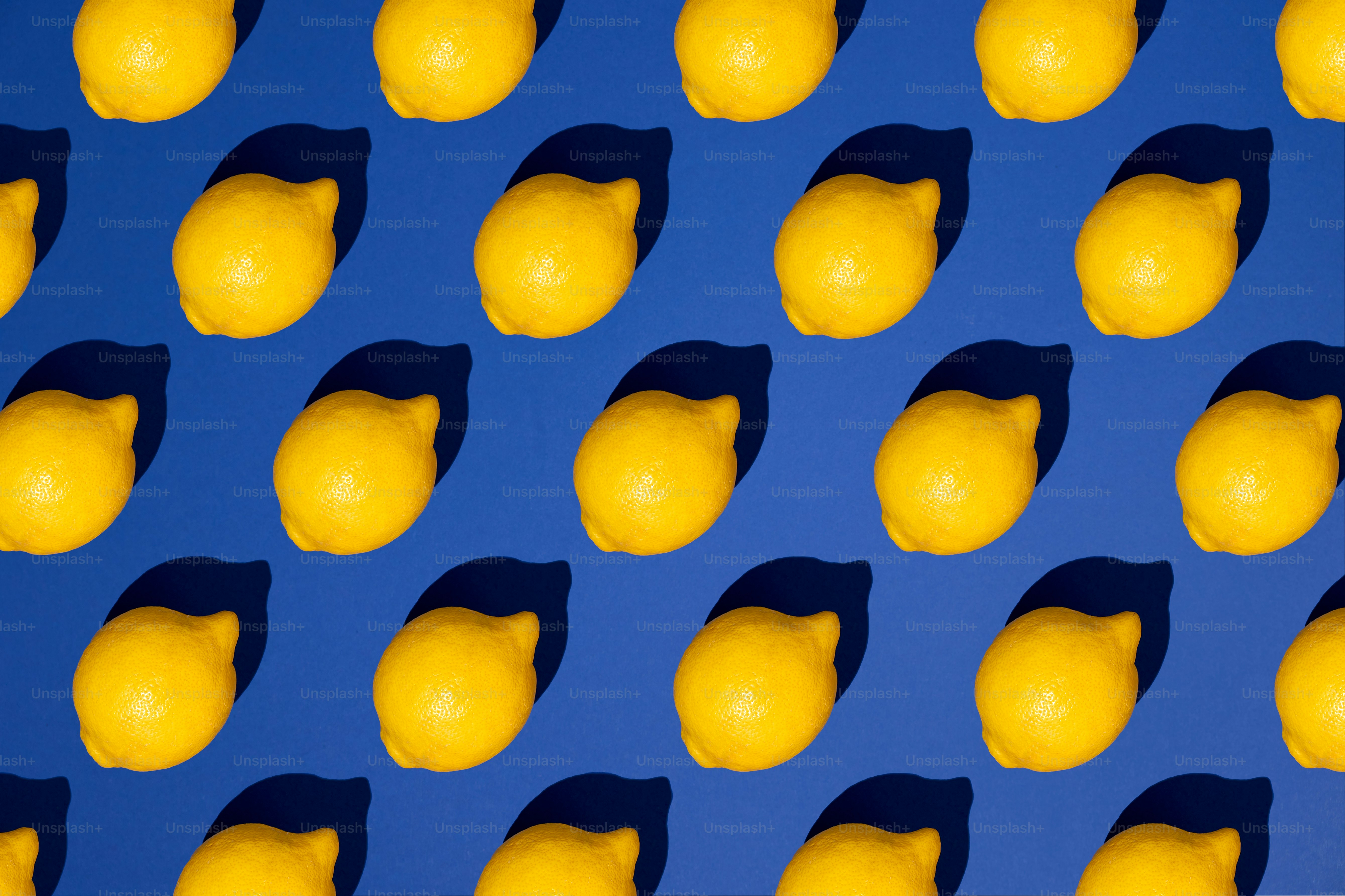 Yellow lemons in a pattern on a blue background.