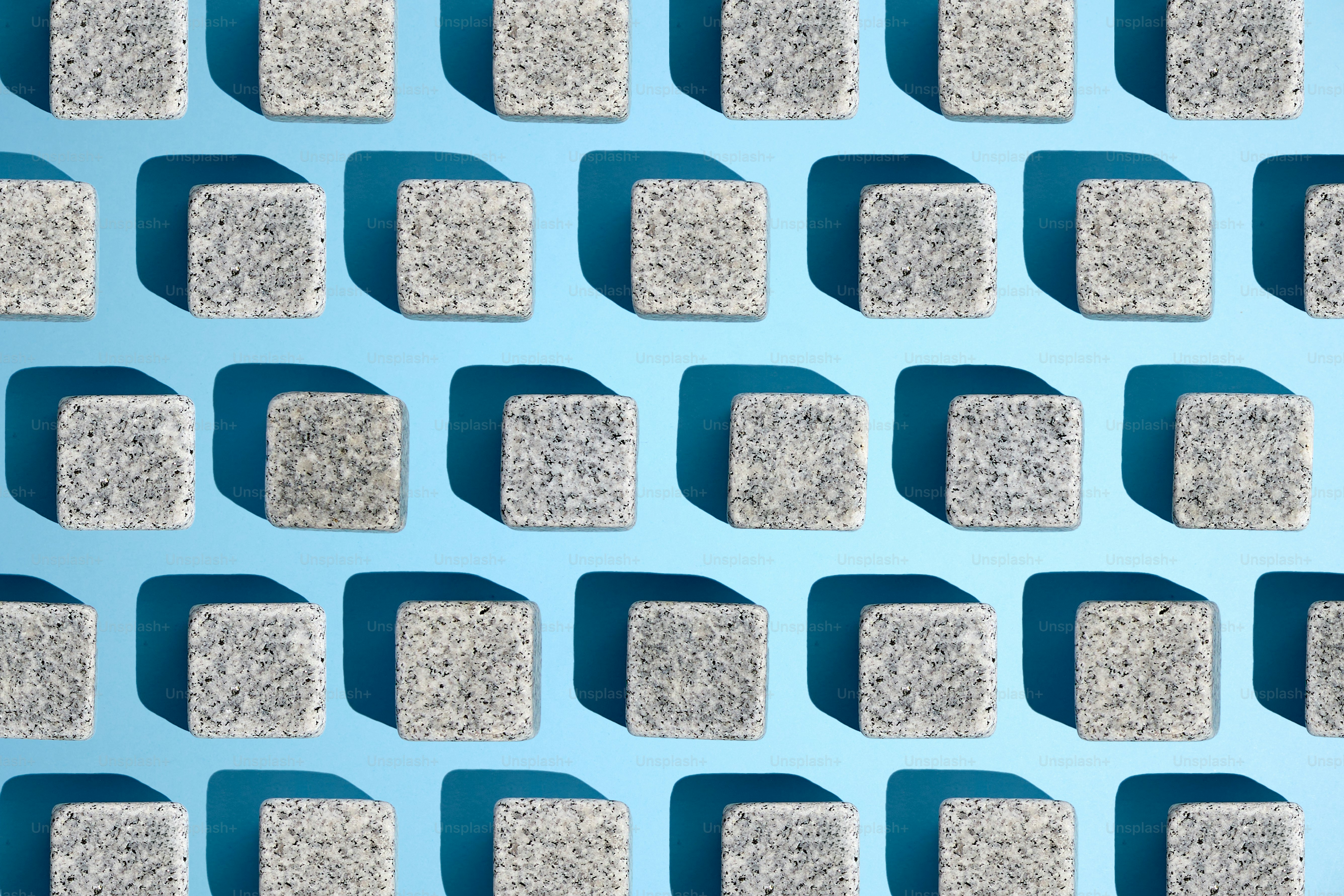 Cubes create a shadow pattern against a blue backdrop.