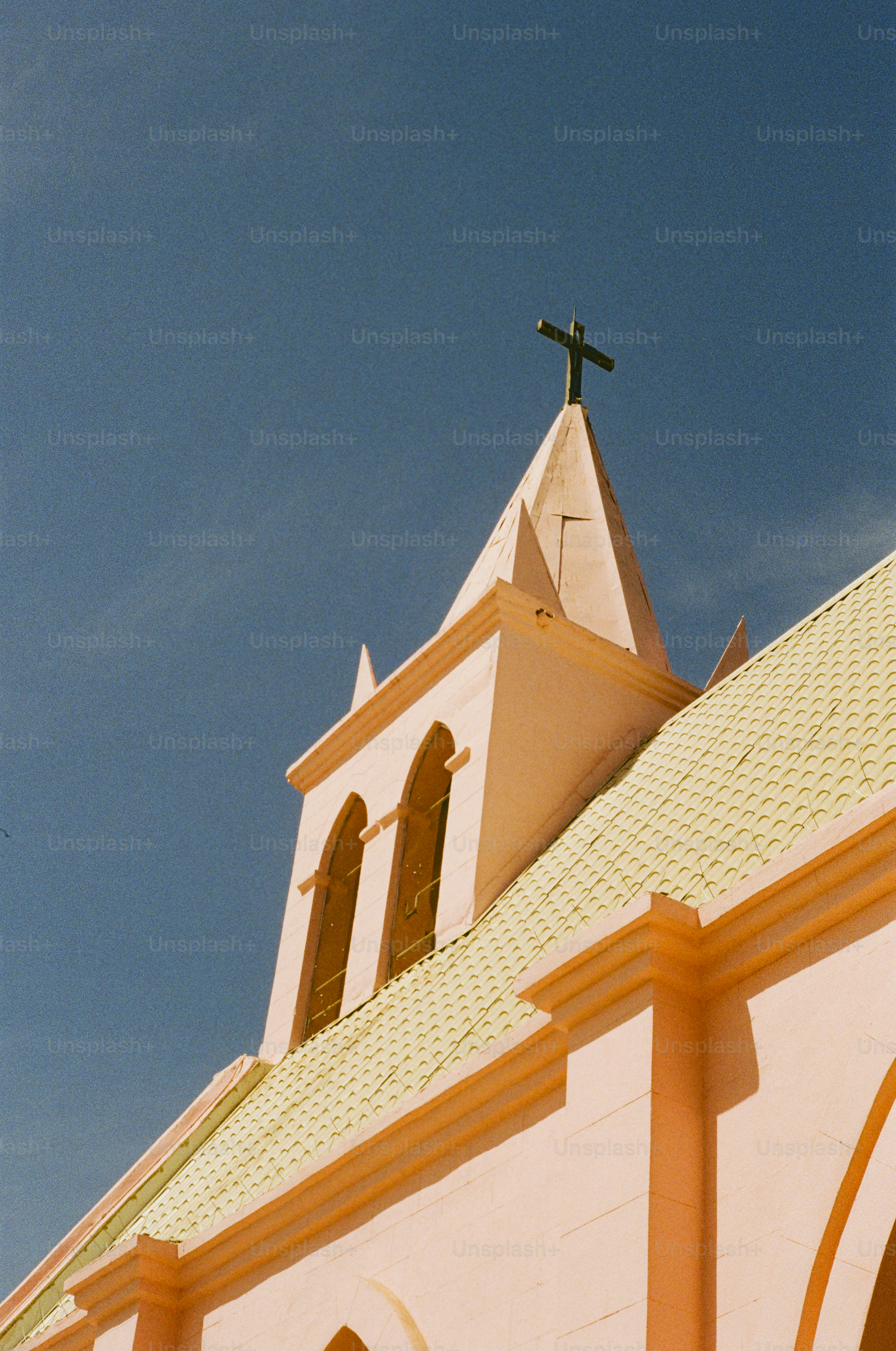 A church steeple reaches towards the sky.