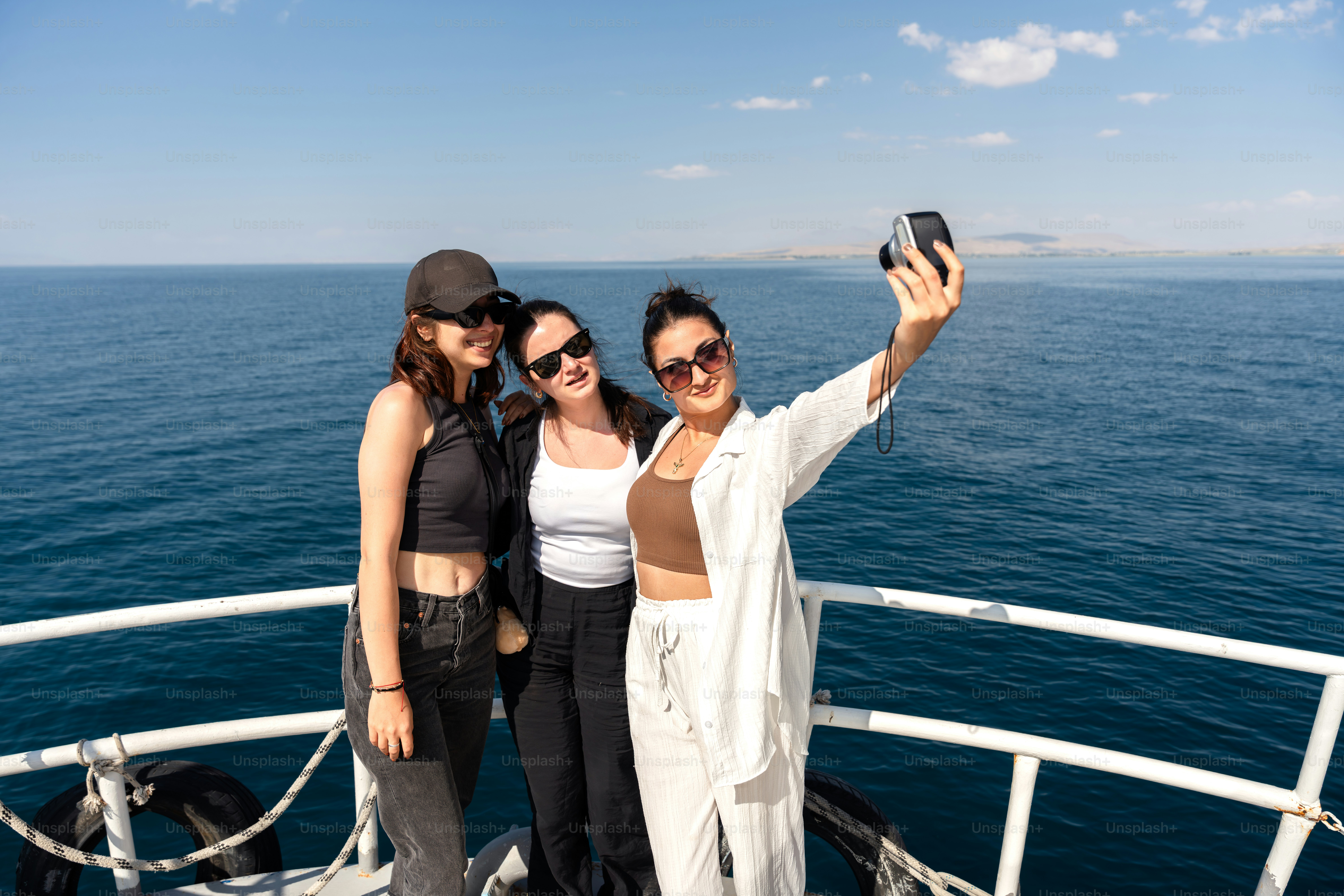 Friends are enjoying a boat ride on a sunny day. photo – Travel Image ...