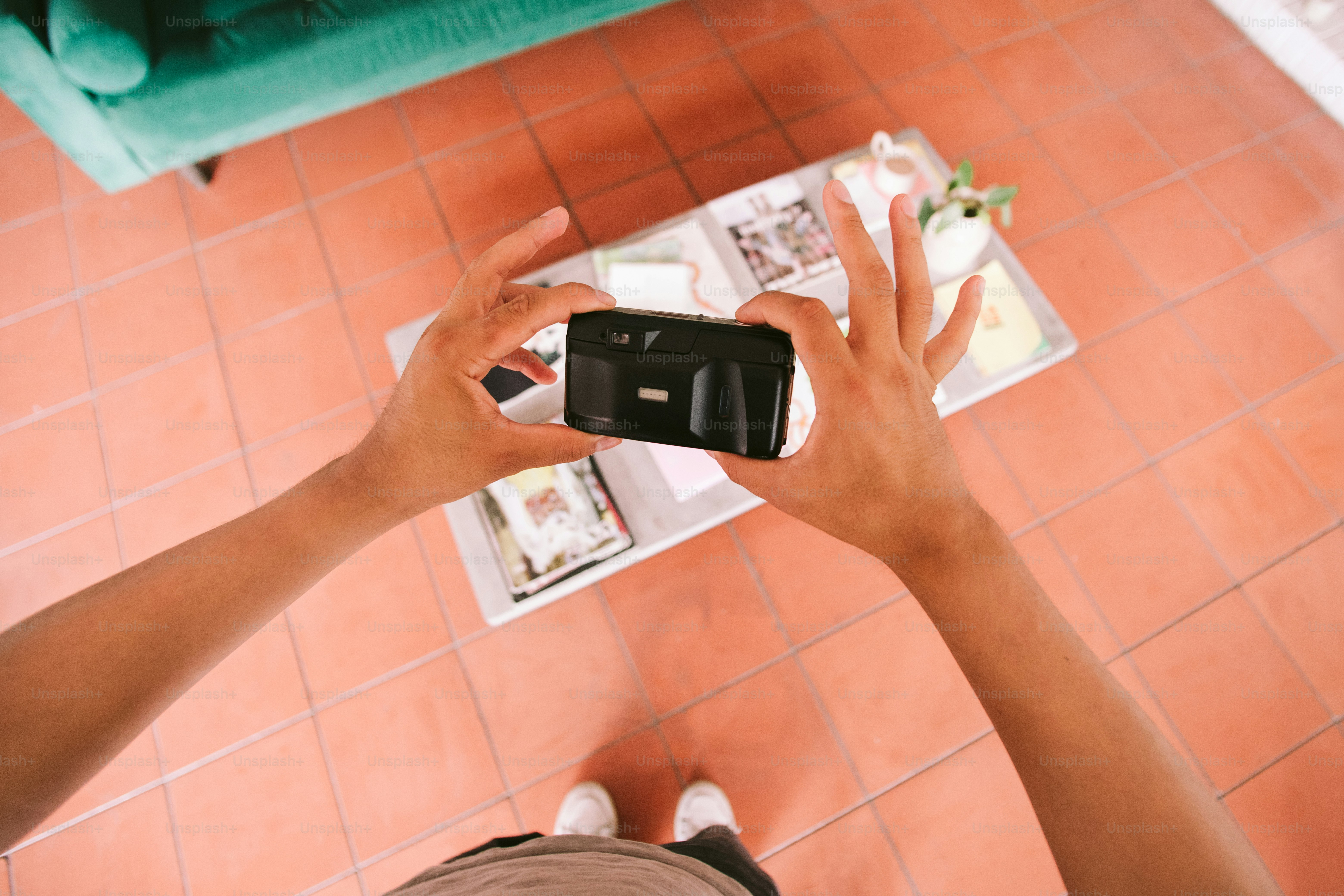 Person taking a photo of a coffee table.