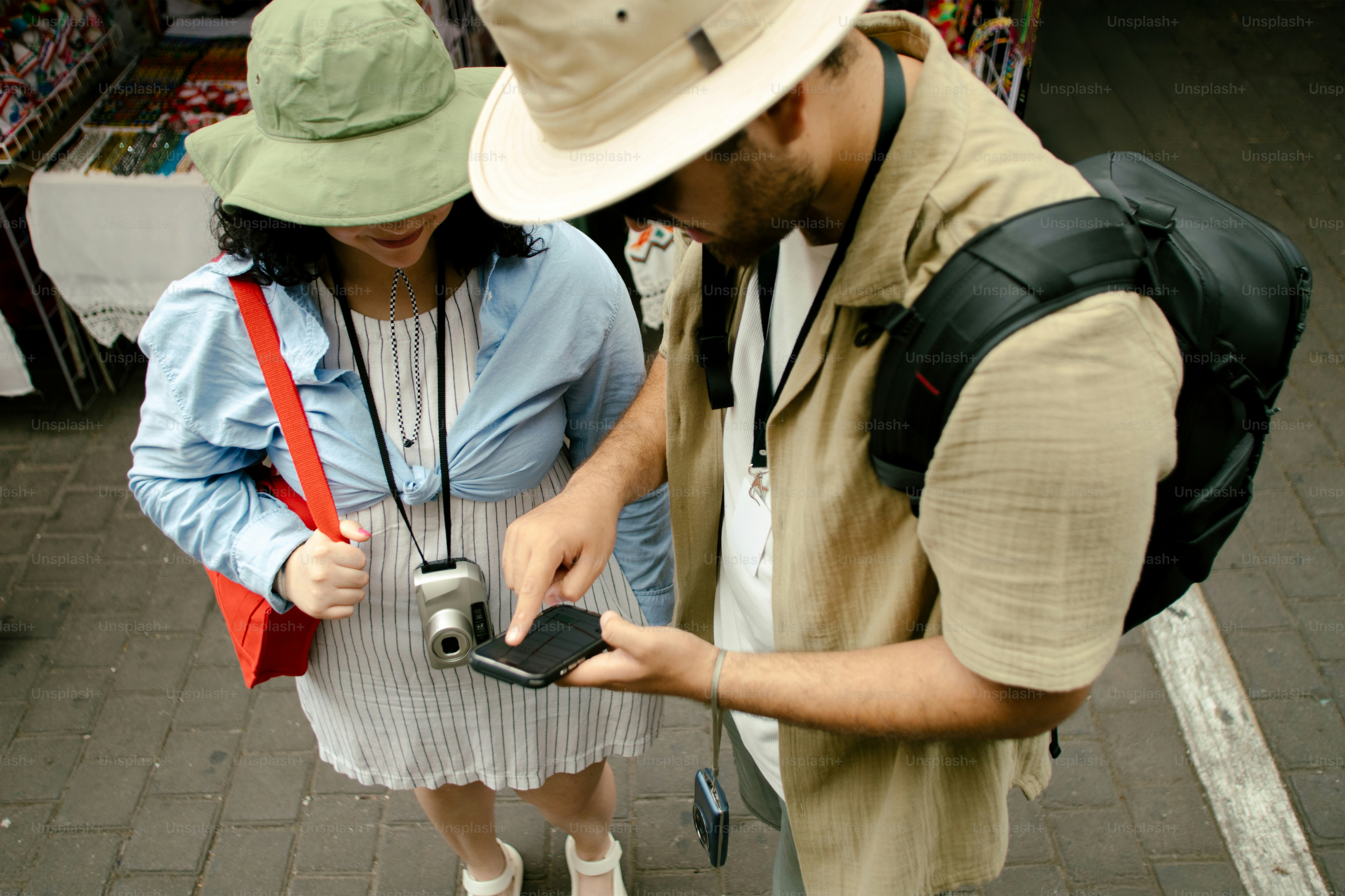 Tourists look at a device, possibly a map.