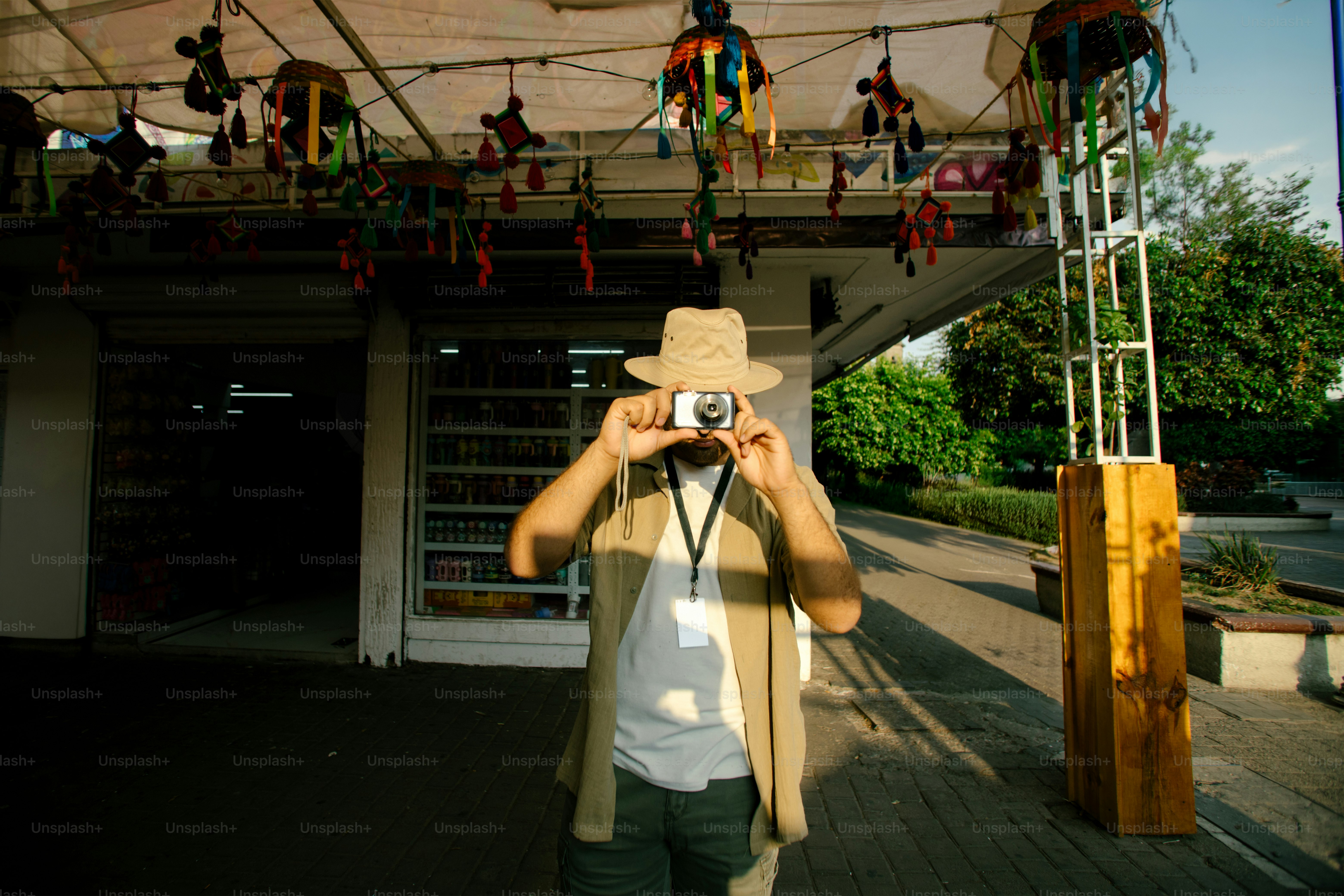 A man takes a picture with a camera.