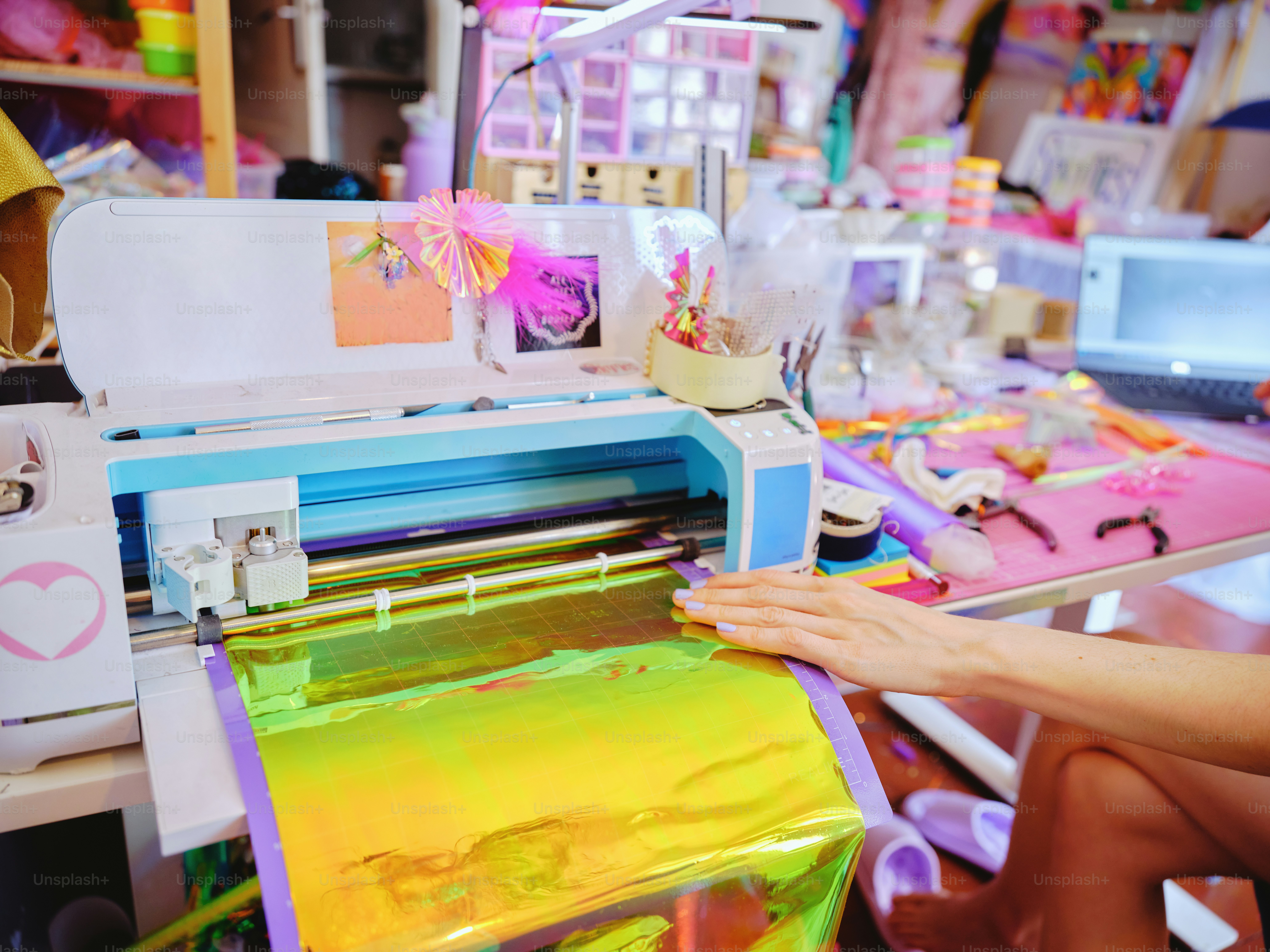 A cutting machine with colorful materials. photo – Designer Image on ...