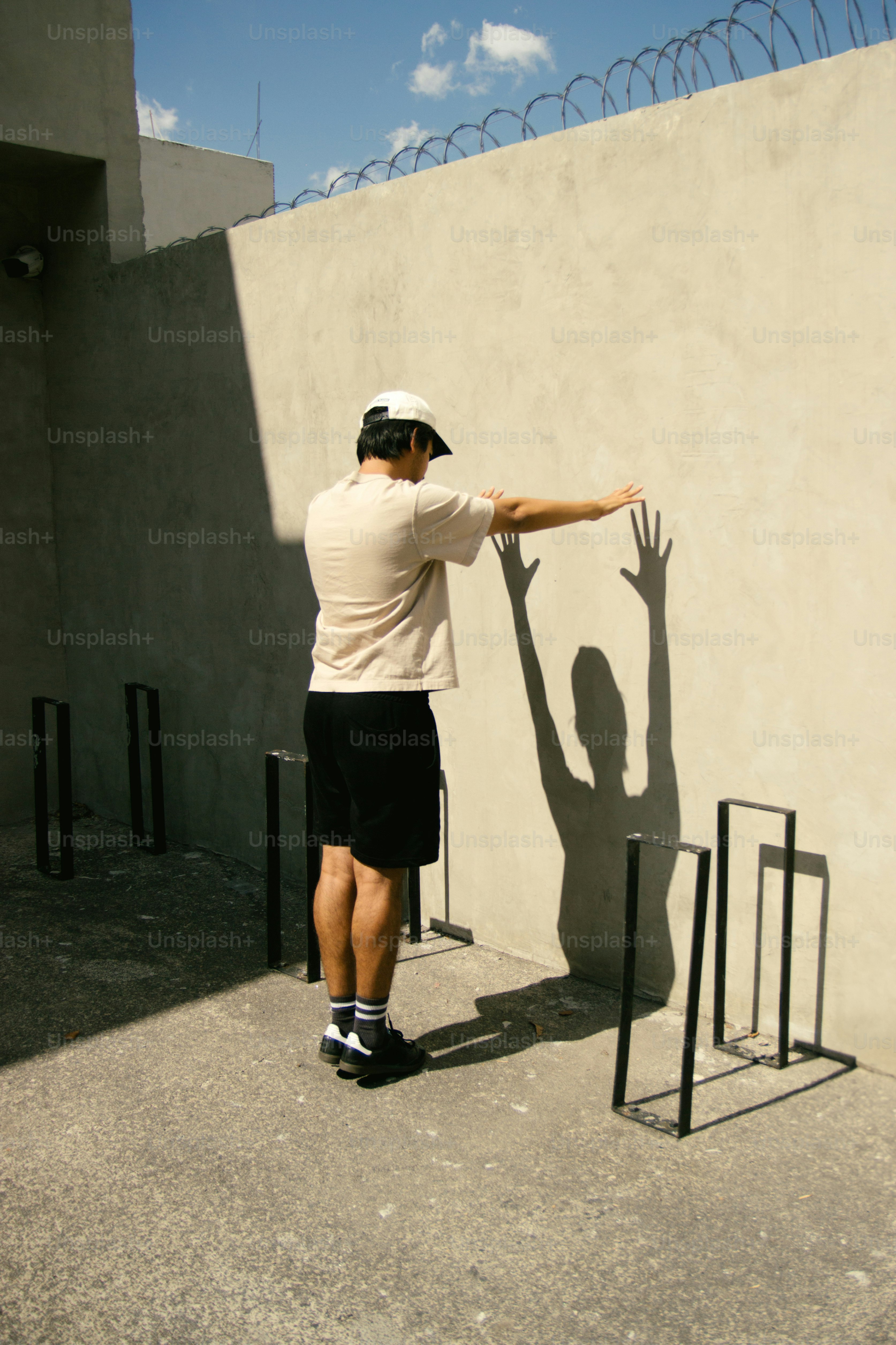 A person's shadow makes a unique gesture.