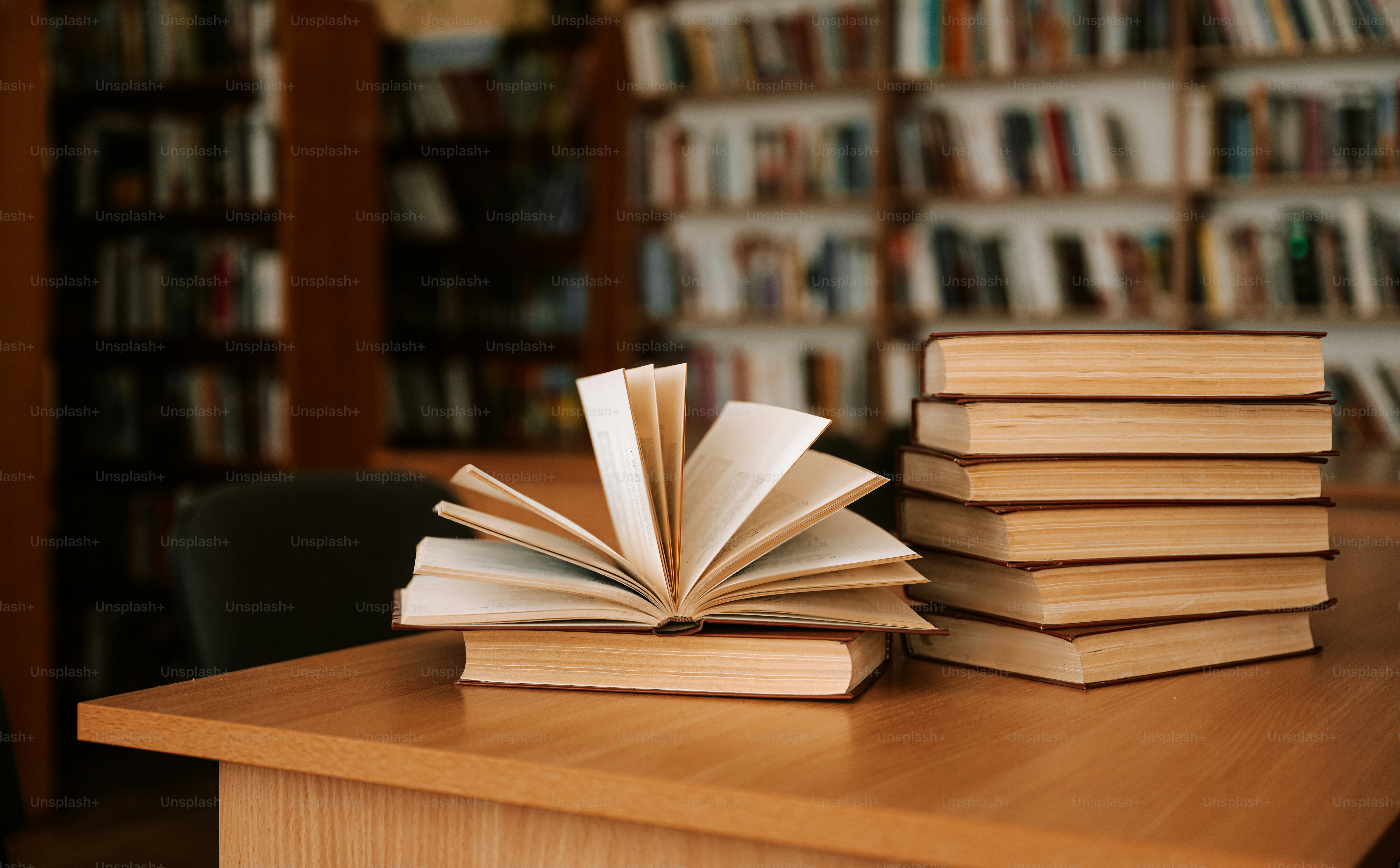 Books open on a table in a library.