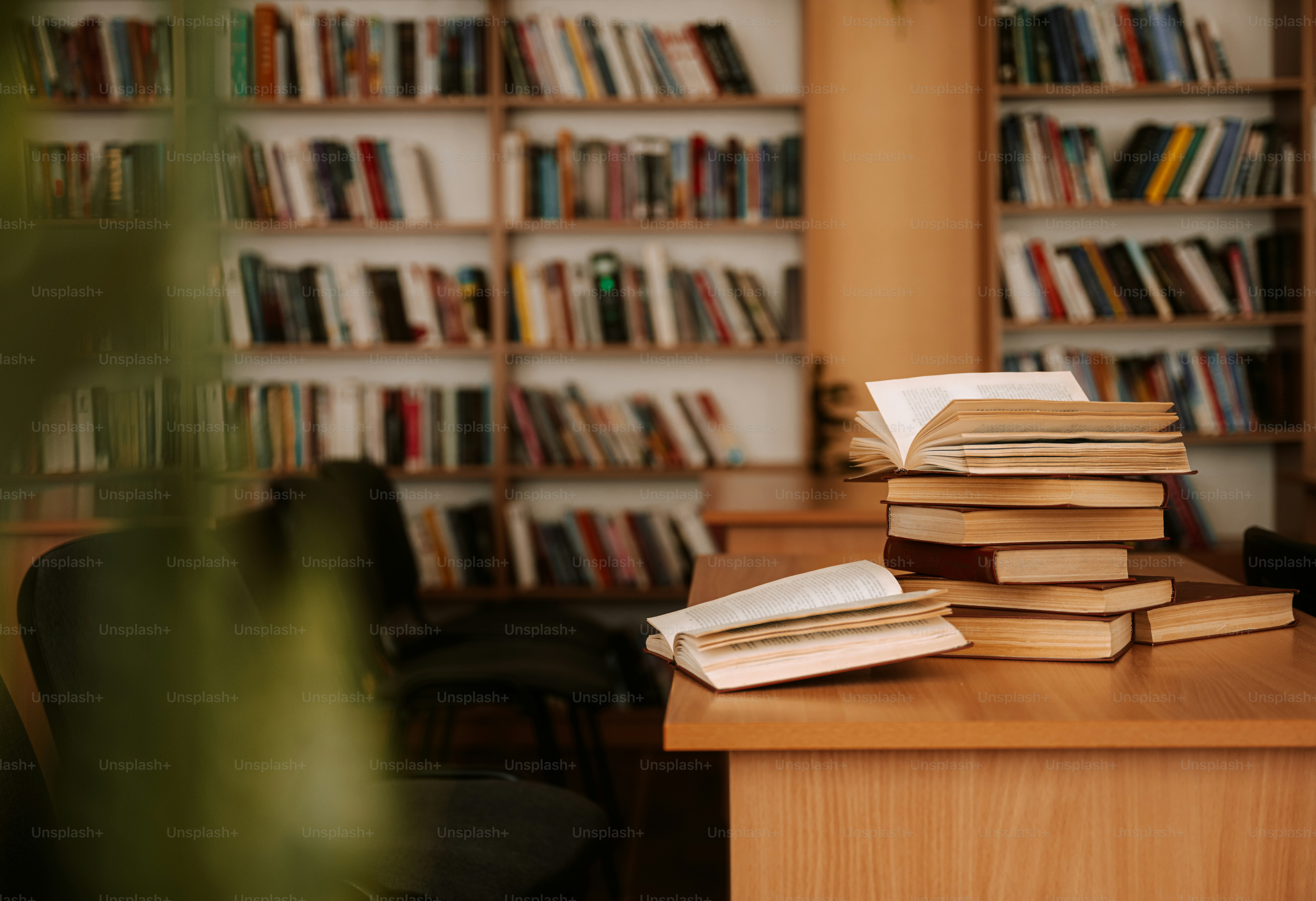 Books rest on a desk in a library. photo – Books Image on Unsplash