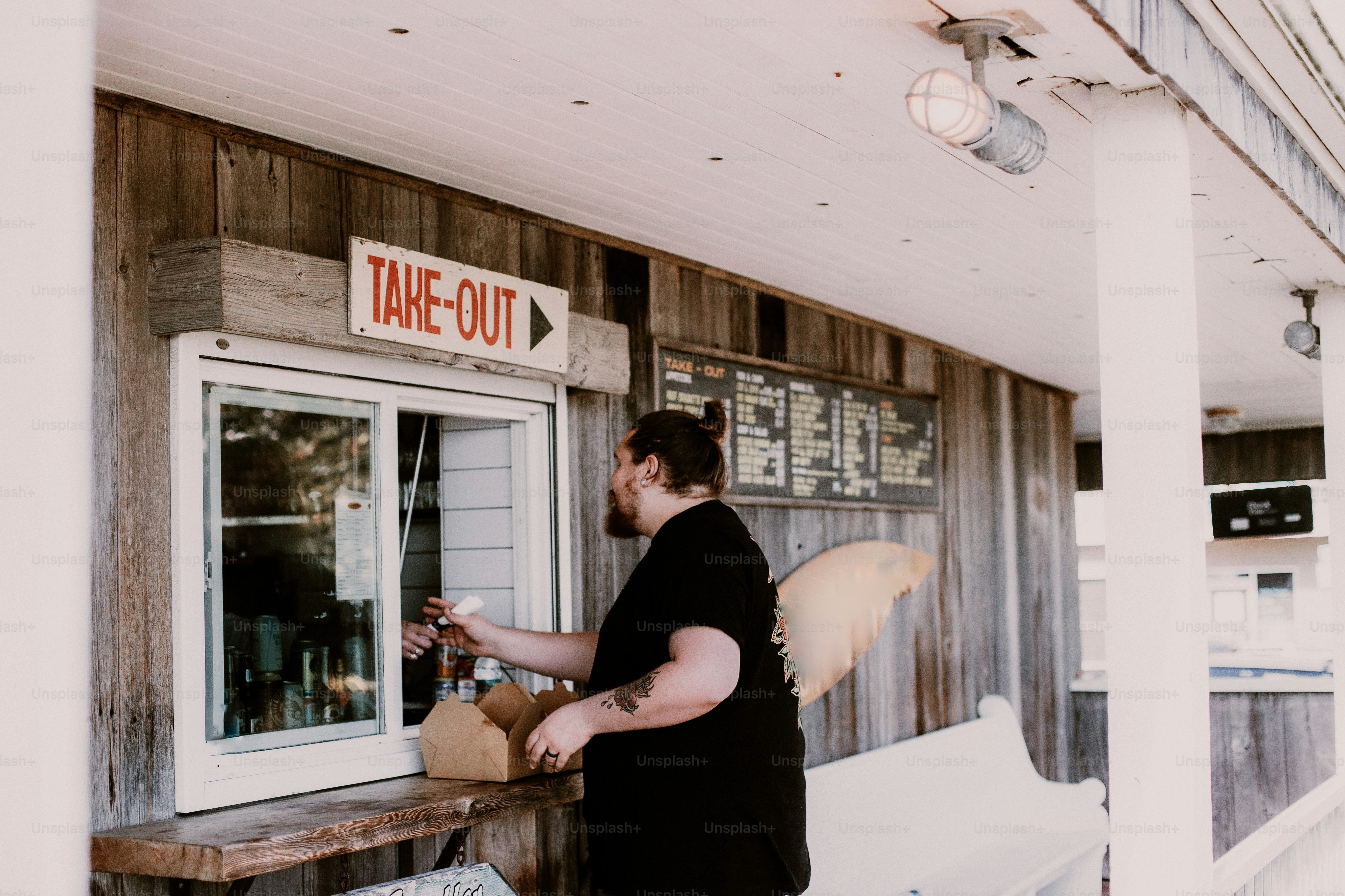A man works the take-out window.