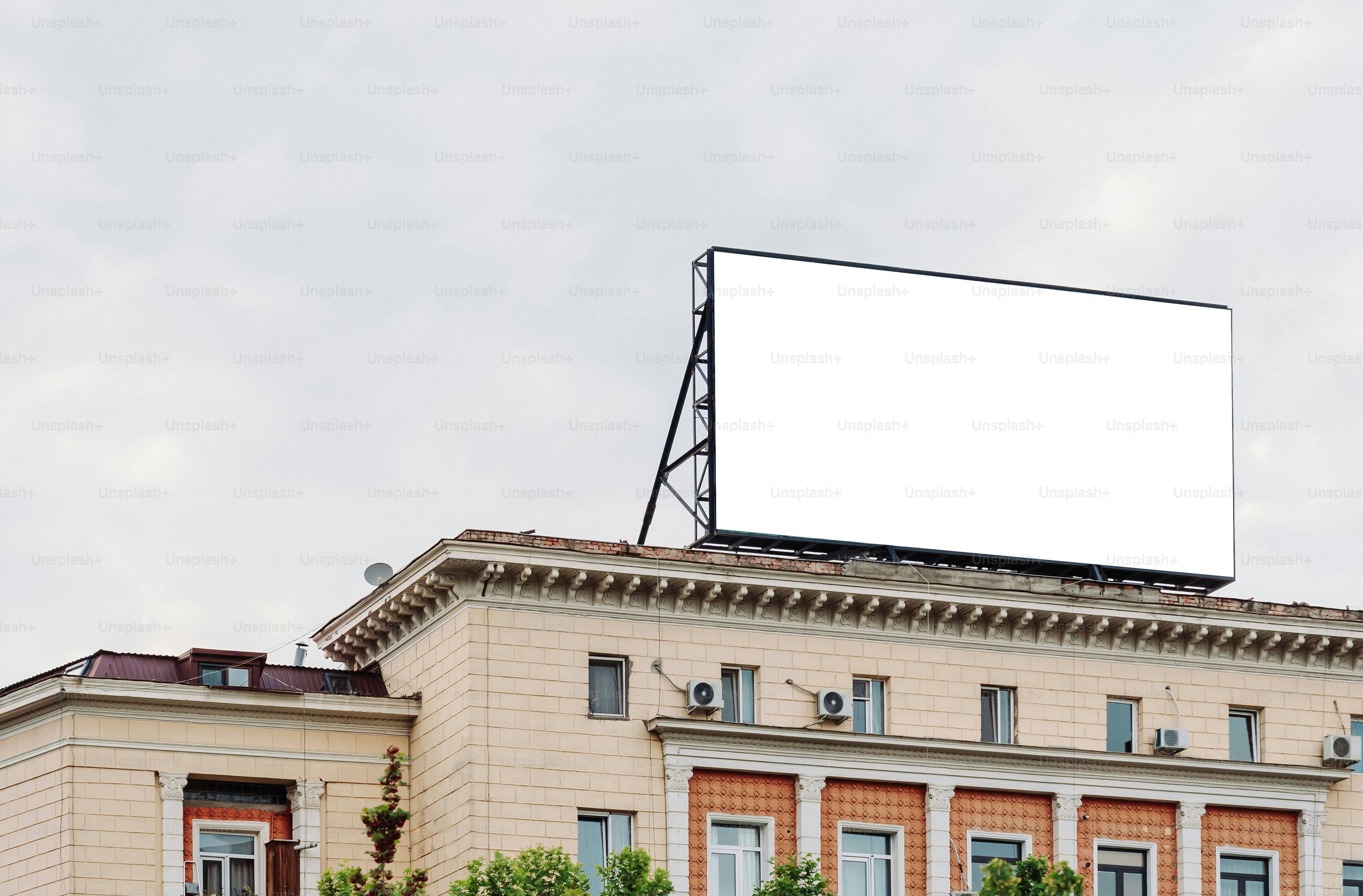A blank billboard sits atop a building.