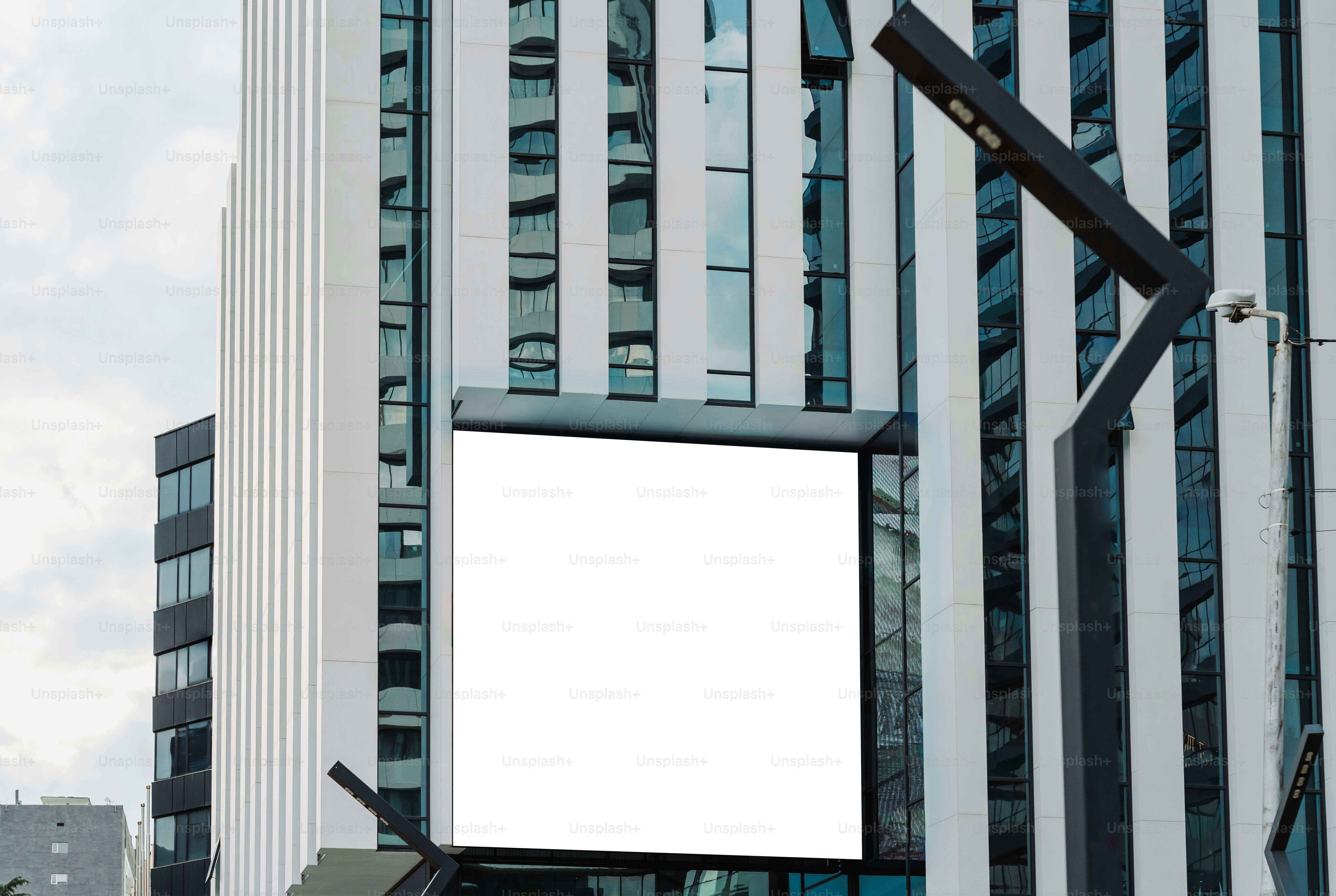 Blank advertising screen is attached to a building.